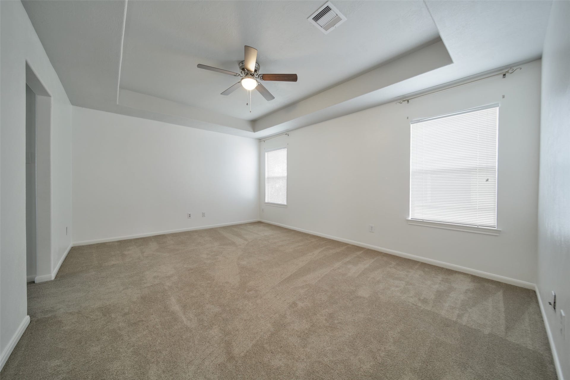 17247 Mitchell Pass Lane, Humble, TX 77346 Spacious and bright Primary bedroom features coffered ceilings and bright windows.