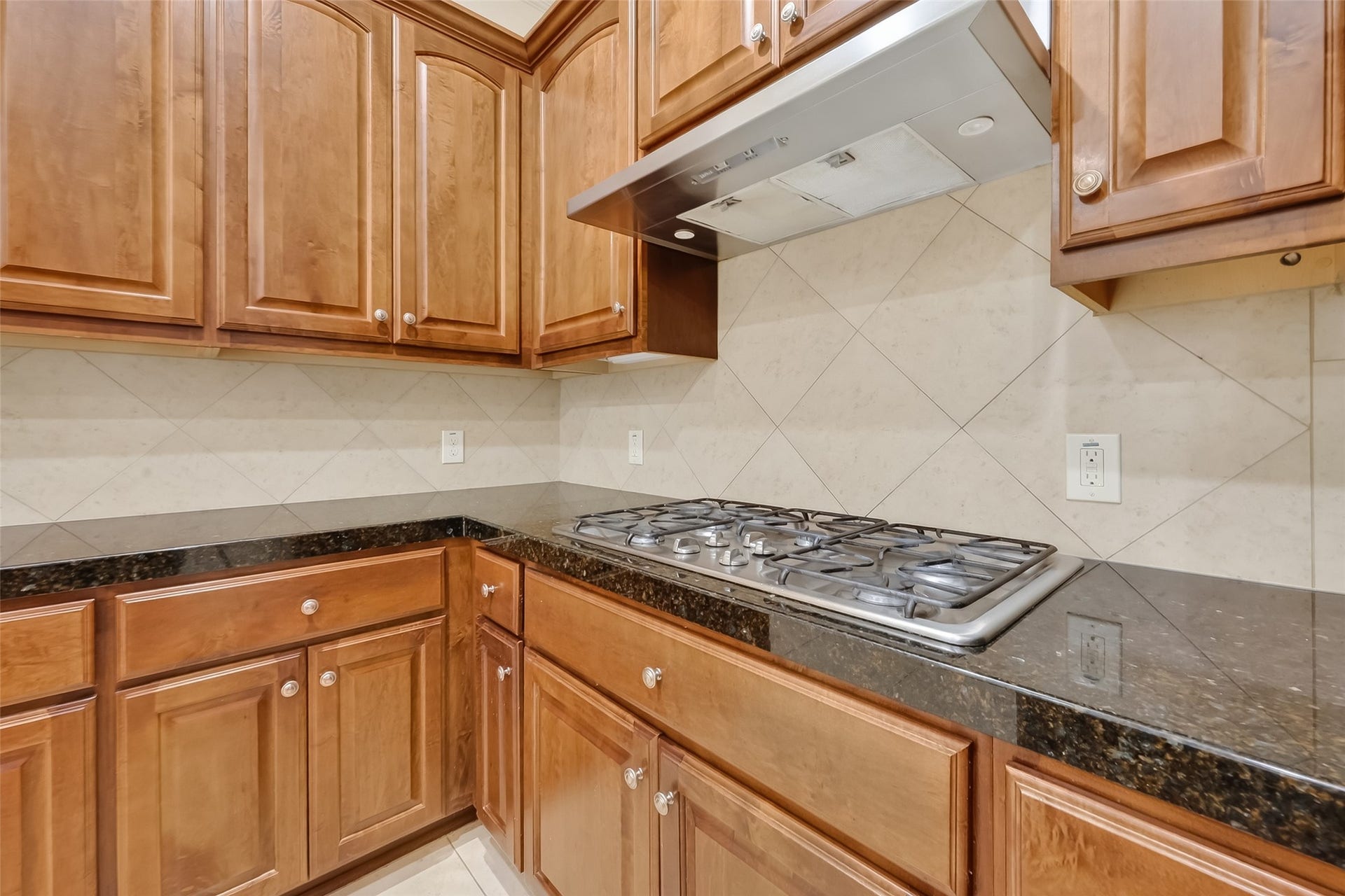 14447 KINGSTON COVE Lane, Houston, TX 77077 Gas Cook Top with 6 burners and stainless steel vent hood.