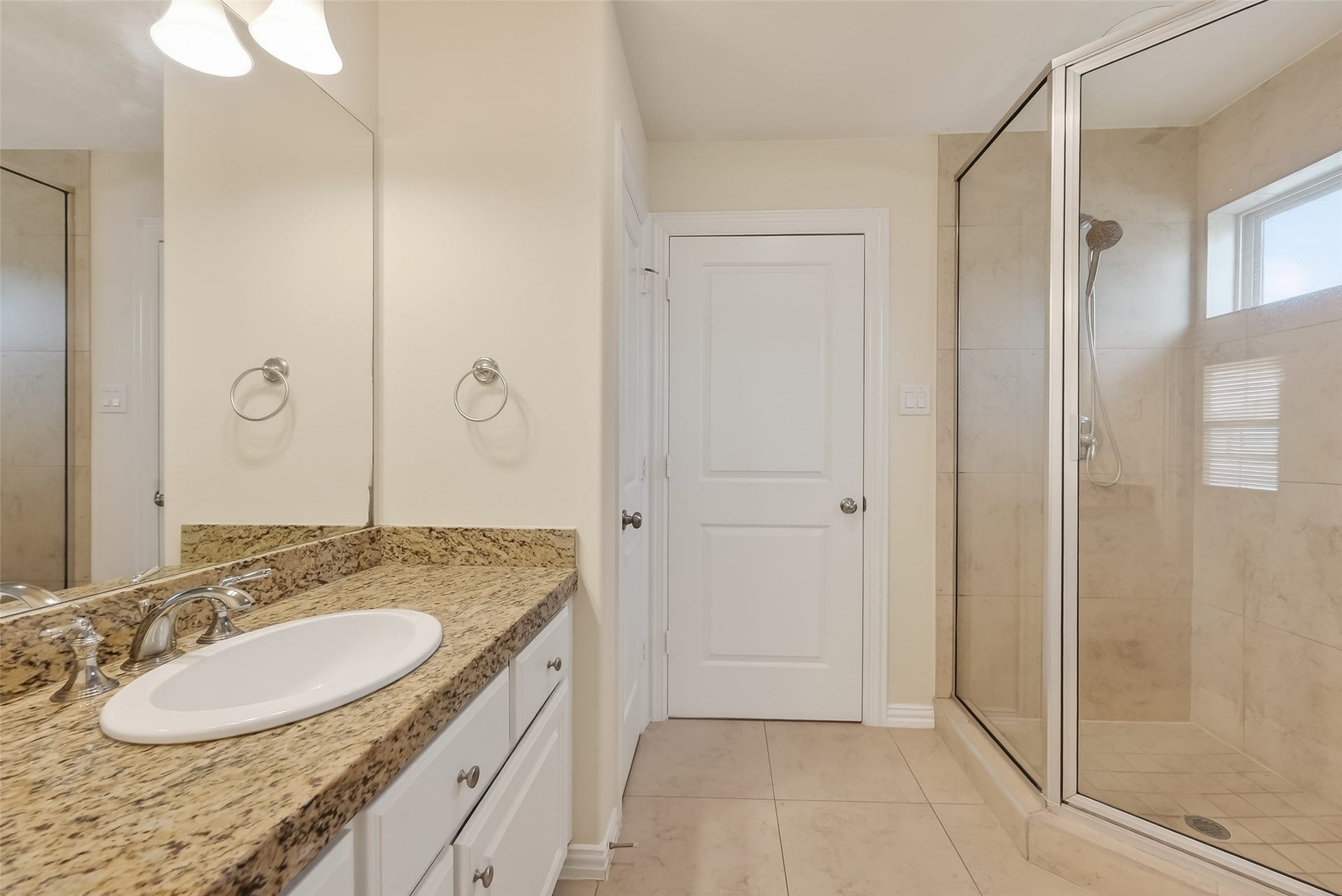 14447 KINGSTON COVE Lane, Houston, TX 77077 Bathroom of the fourth bedroom that opens to Game Room. Offers endless granite countertop, wall to wall mirror and a shower.