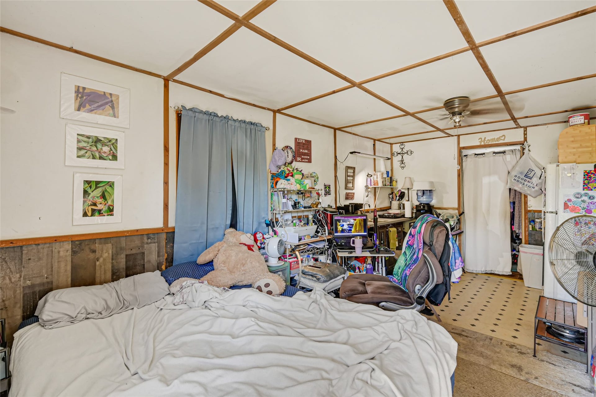 121 Patterson Road, #CR814, Brazoria, TX 77422 Cozy bedroom with rustic wood accents, featuring a comfortable bed and ample space for a home office setup.