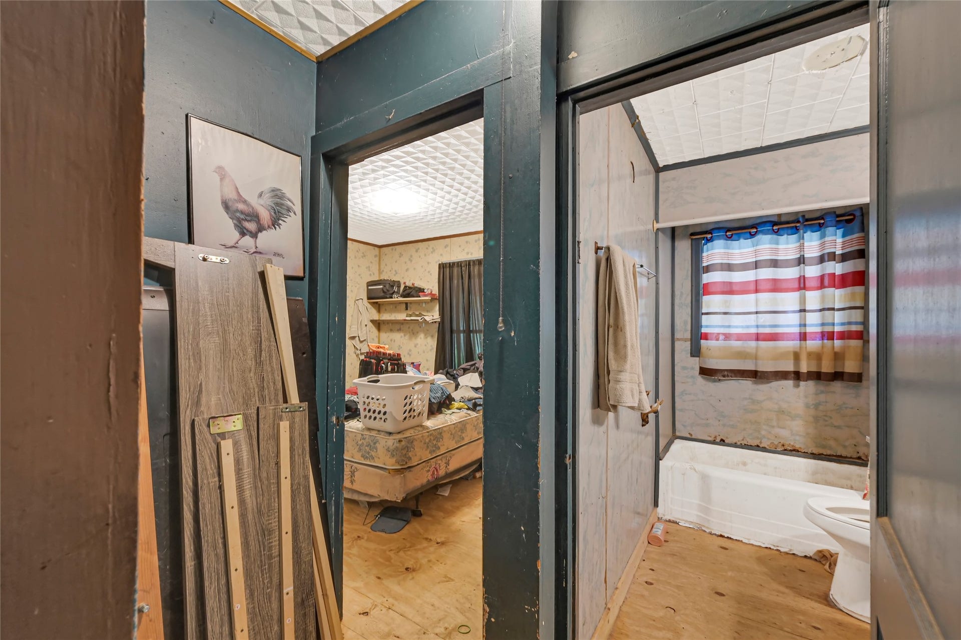 121 Patterson Road, #CR814, Brazoria, TX 77422 Cozy space with potential, featuring a bathroom with a tub and shower combination, complemented by a nearby room ready for customization or renovation.