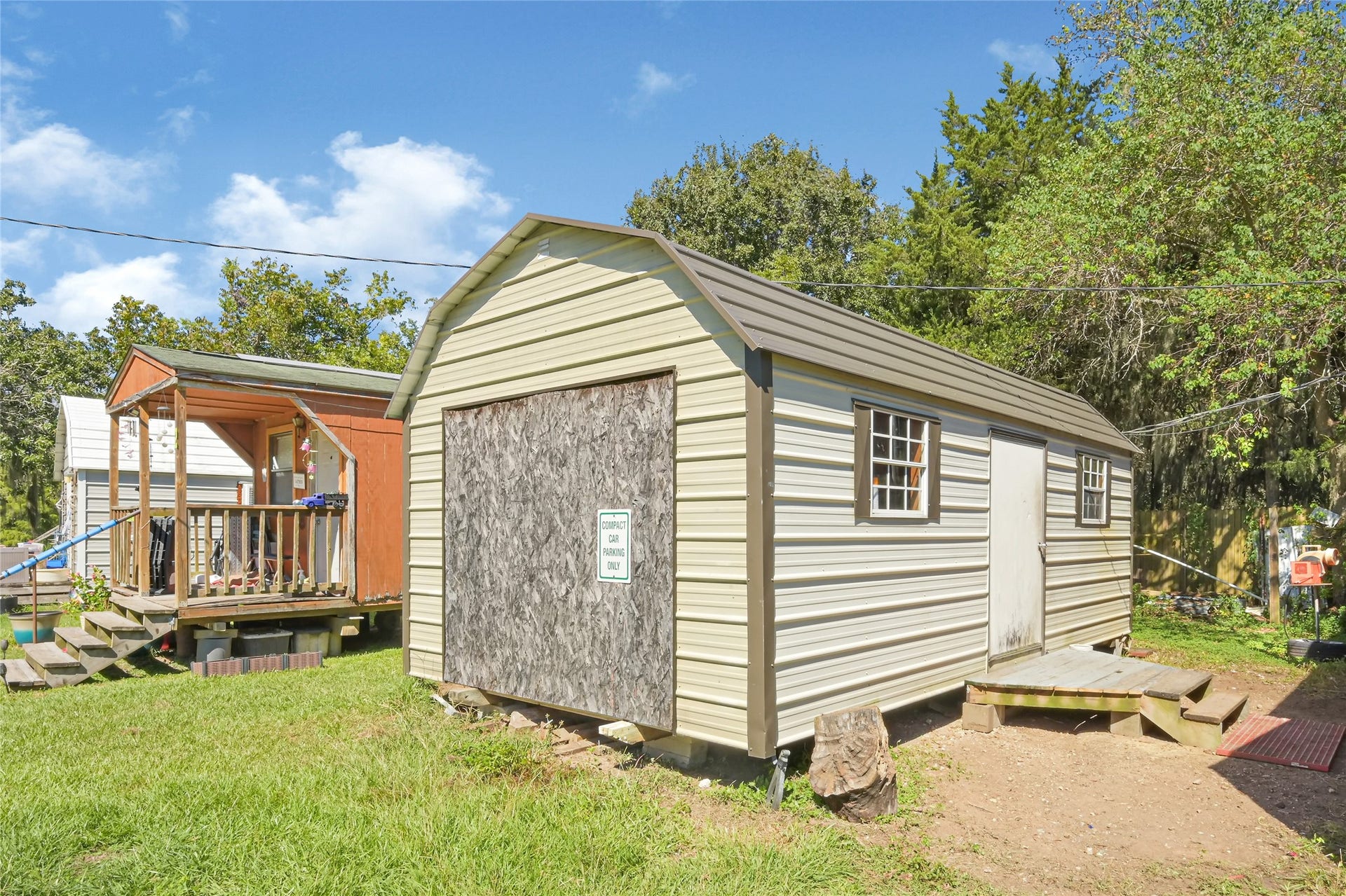121 Patterson Road, #CR814, Brazoria, TX 77422 Spacious storage shed with a classic metal roof and windows, perfect for extra storage or a workshop, set on a lush, green lawn.