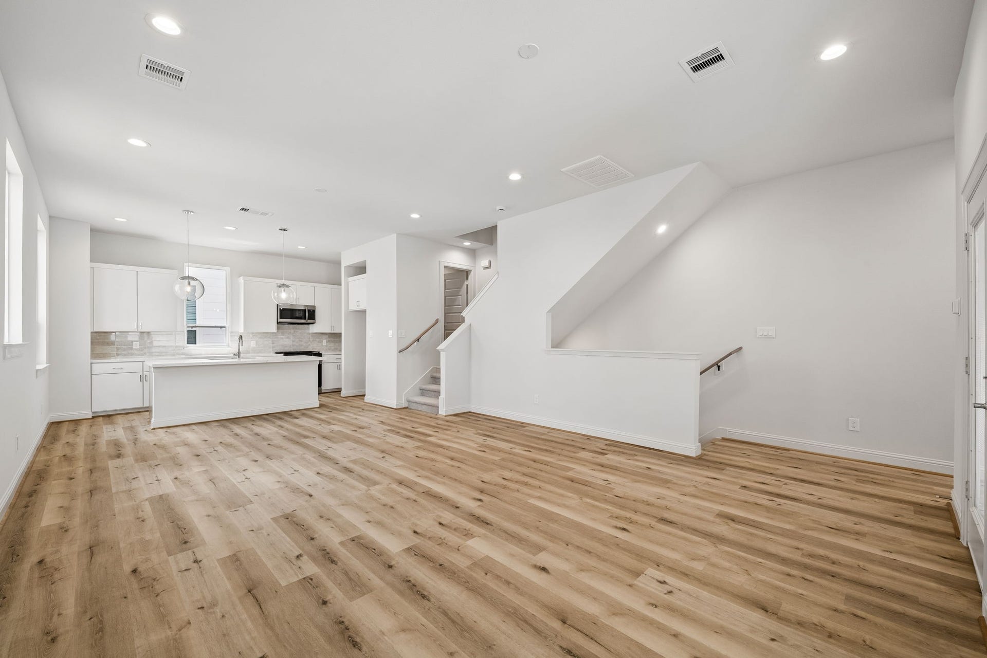 Experience seamless modern living in this open-concept space, featuring sleek kitchen finishes, a spacious dining area, and a bright living room perfect for entertaining.