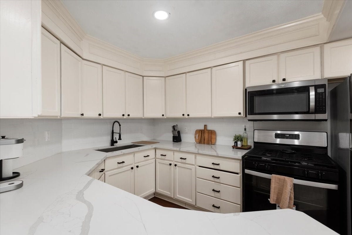 215 Caplin Street, Houston, TX 77022 Downstairs Kitchen features abundant cabinetry and counter space.