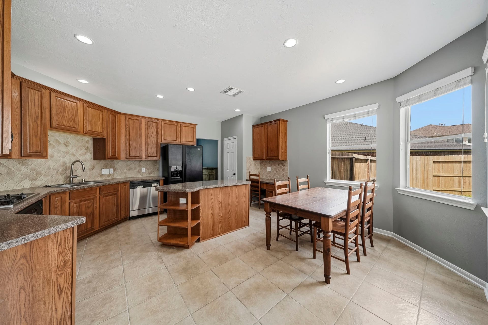 5507 Sandy Trace Court, Katy, TX 77494 Another perspective showcases the kitchen's generous proportions, extensive cabinetry, and spacious center island. The open arrangement provides easy access to the adjoining breakfast area, creating a comfortable setting for everyday meals and casual gatherings.