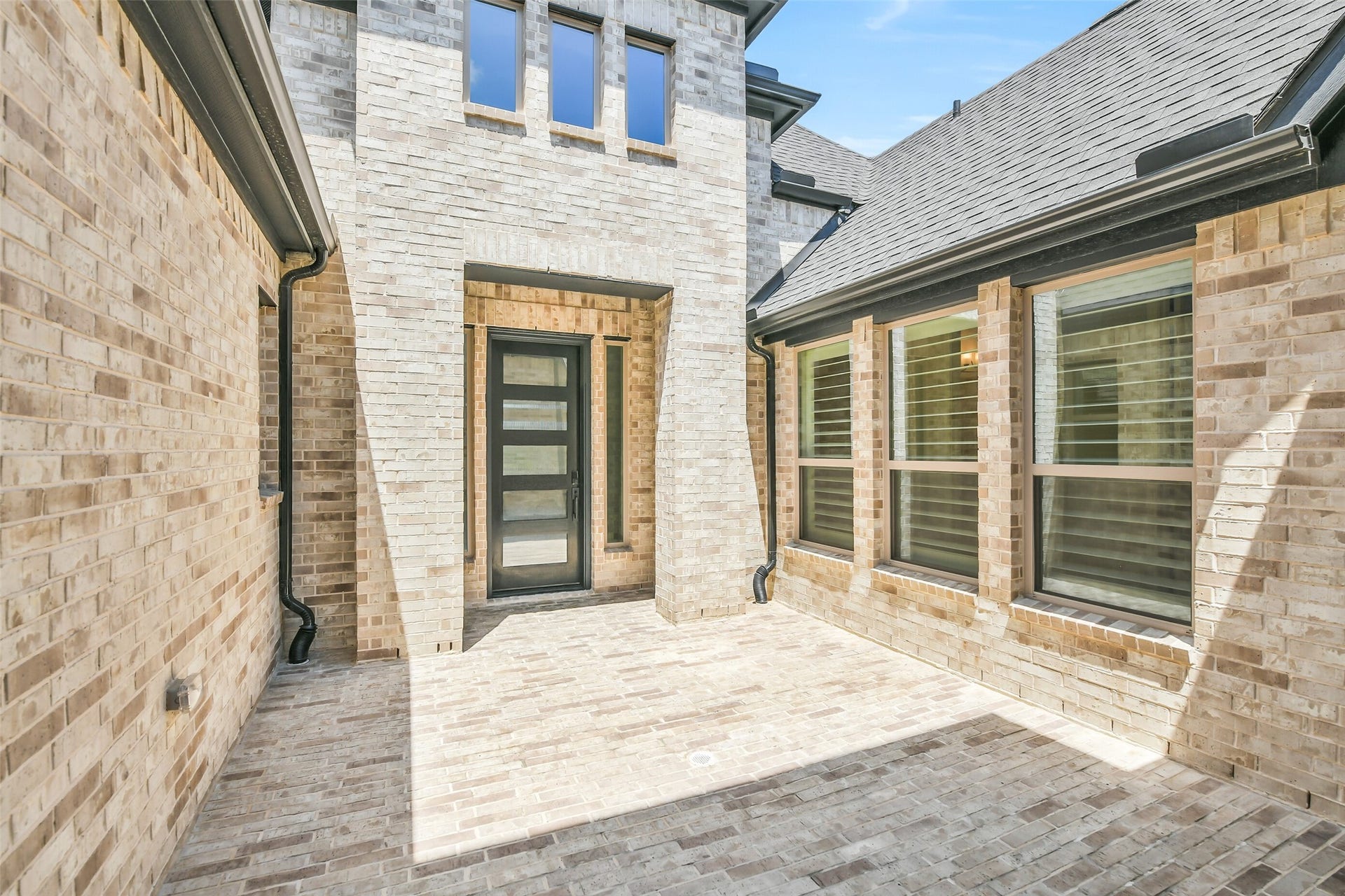 The brick front courtyard measures 13x14.  Owners have added a Holiday Lighting Soffit Duplex Outlet.
