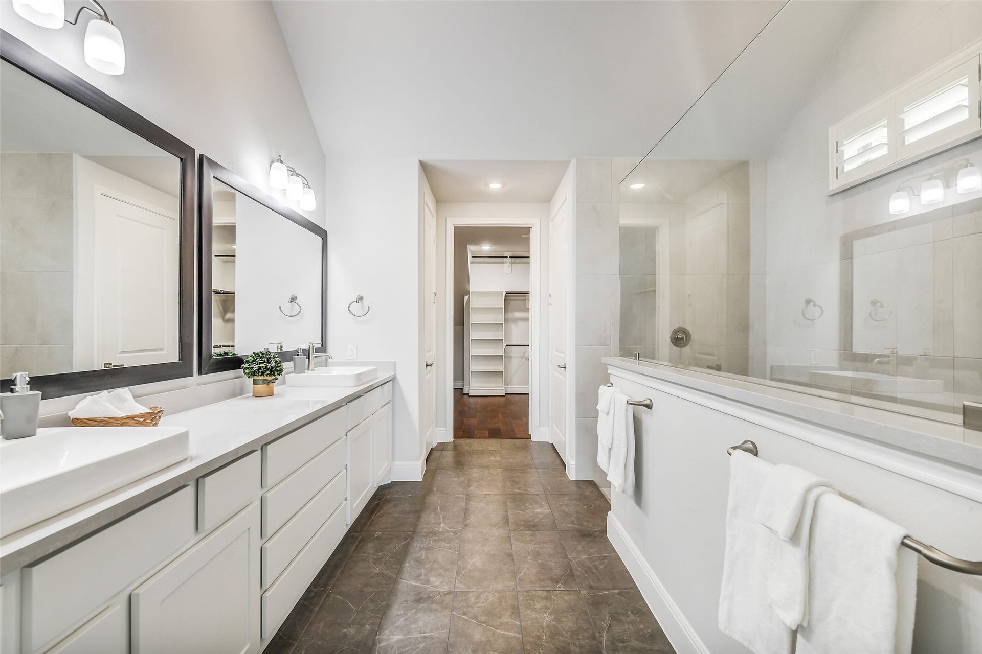 This primary bath is 13 x14, with two vanity spaces and two quartz composite sinks and soft close drawers and cabints.