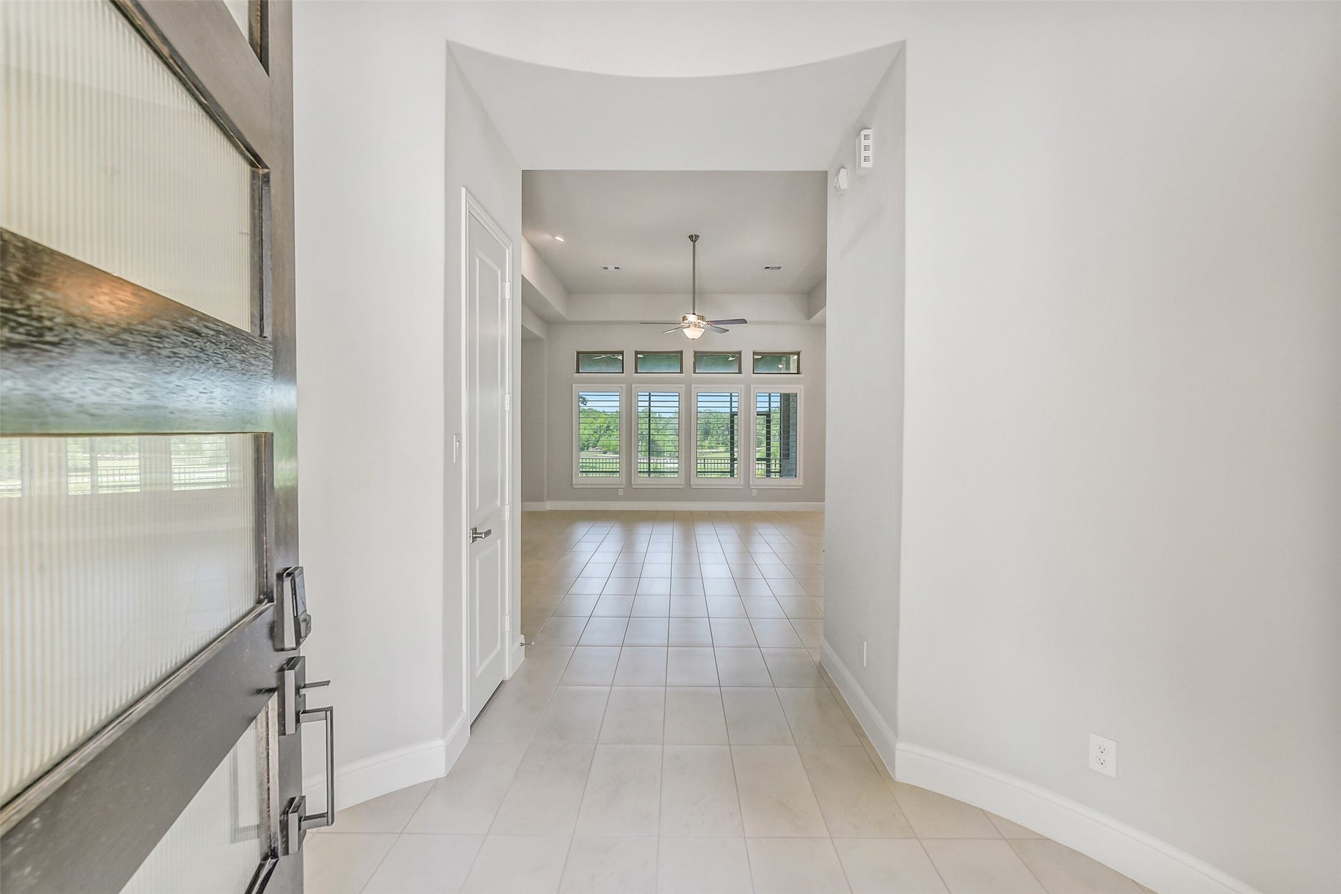 Open the 8 foot Ebony stained front door with 5 windows and you are greeted by a tiled entry hall with high ceilings.
