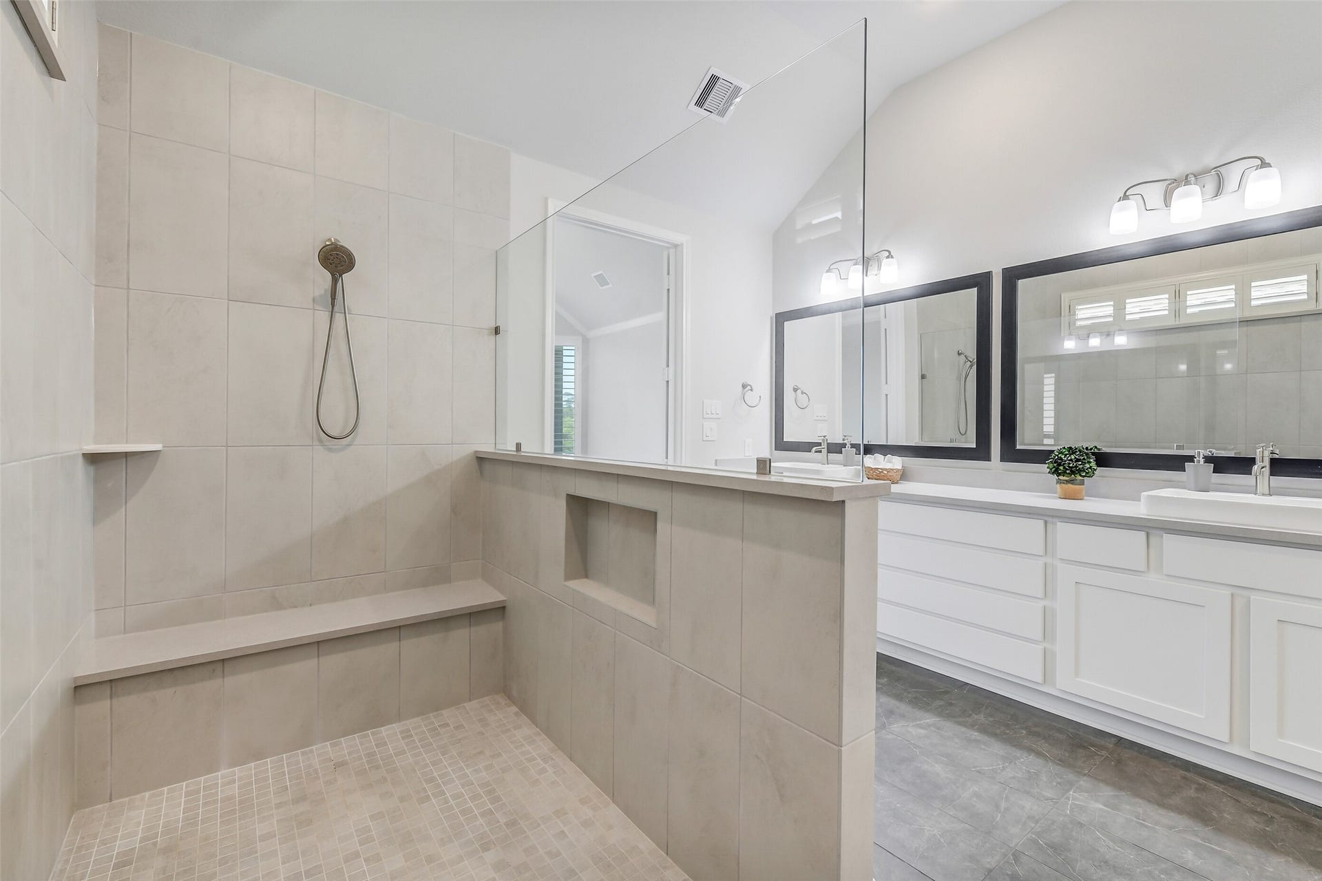 Shower has a bench and shelf and inset for convenience of holding shampoo, etc.