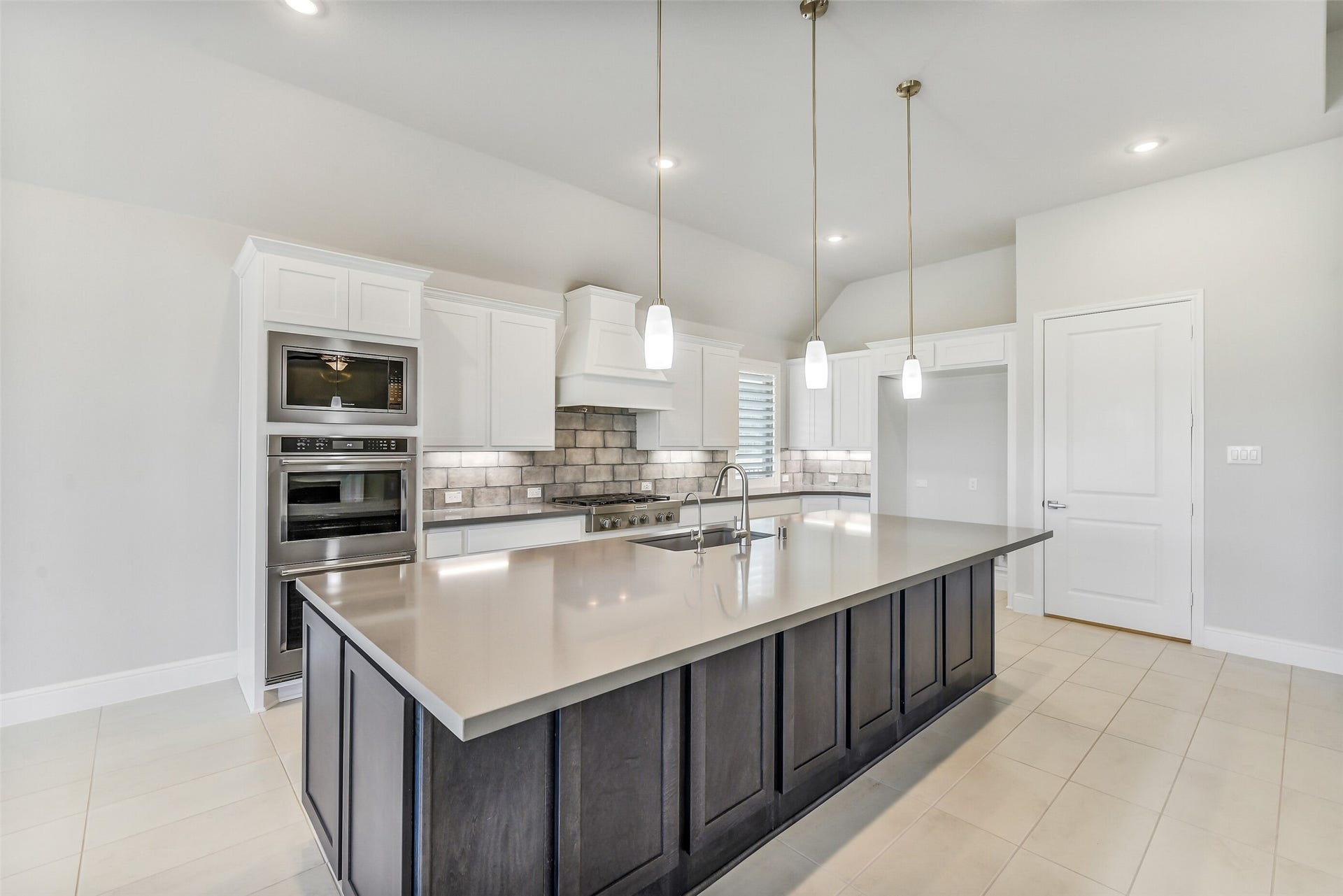 The drawers in the kitchen and throughout the house are soft close hinges and drawer guides.  There is a 2 drawer stack pull outs under the cooktop.  There is plenty of storage in the cabinets located in the island, including on either end.