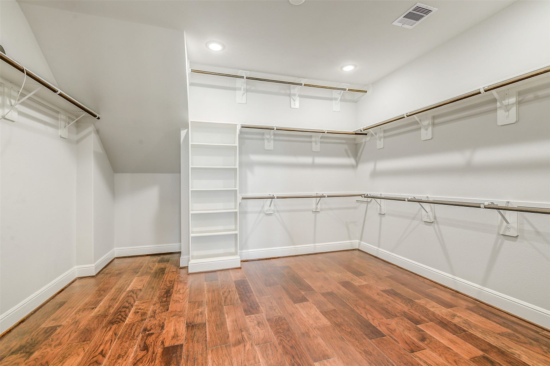 This closet is amazing measuring 13x14 with a little extra space for storage.  Notice the high rod for off season storage.