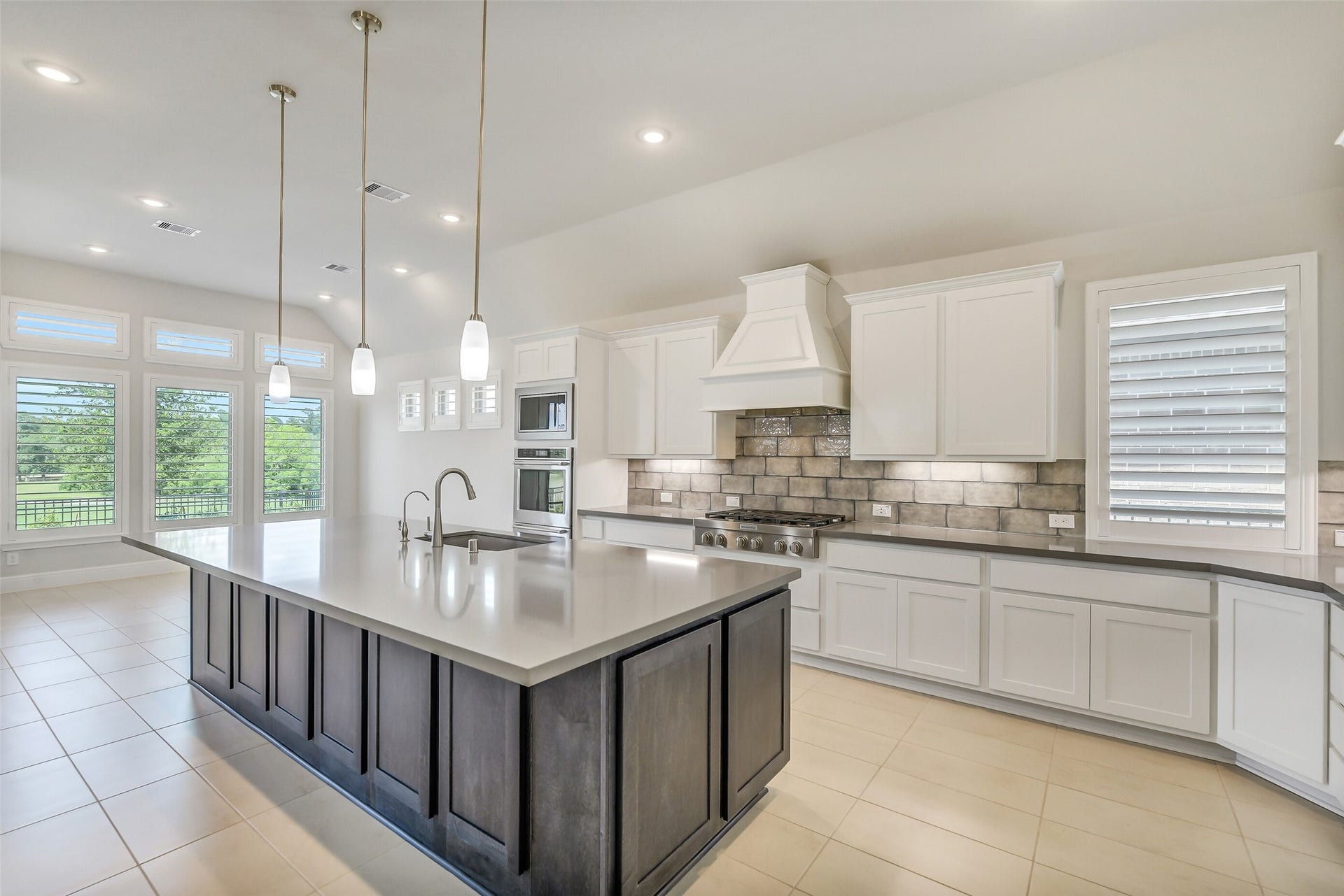 The kitchen has stainless steel Kitchenaid appliances including six burner cooktop, double ovens and a microwave.