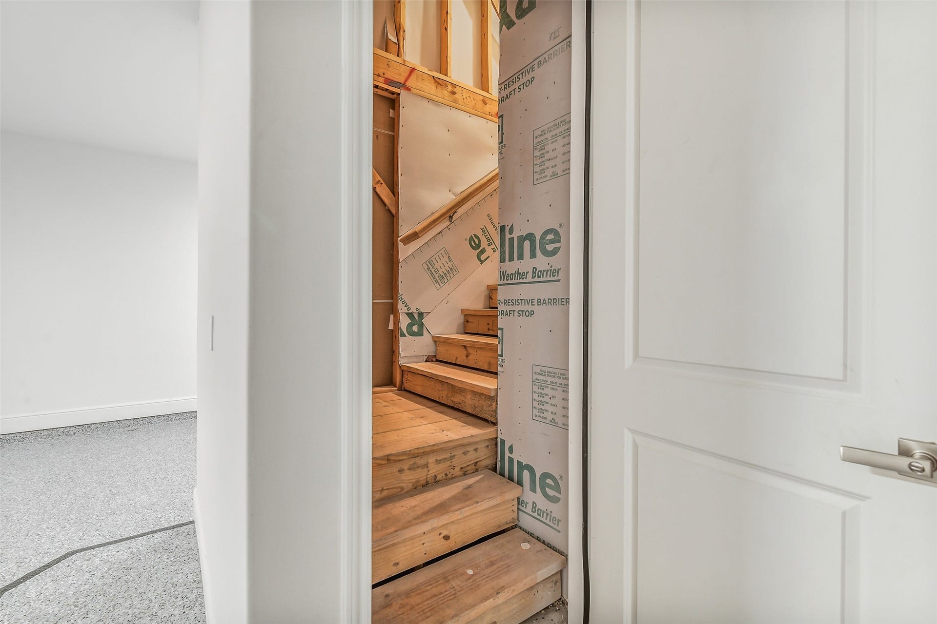 Hiding up the stairs in the garage is unfinished storage.
