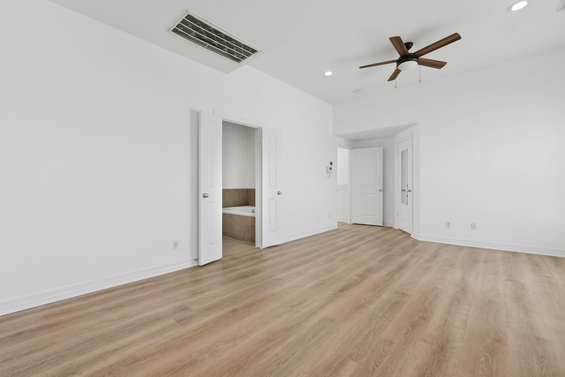 3882 Center Street, Houston, TX 77007 The primary bedroom offers another perspective of its generous layout, highlighting the vaulted ceiling and open wall space that allow for flexible room arrangements. (3rd floor)