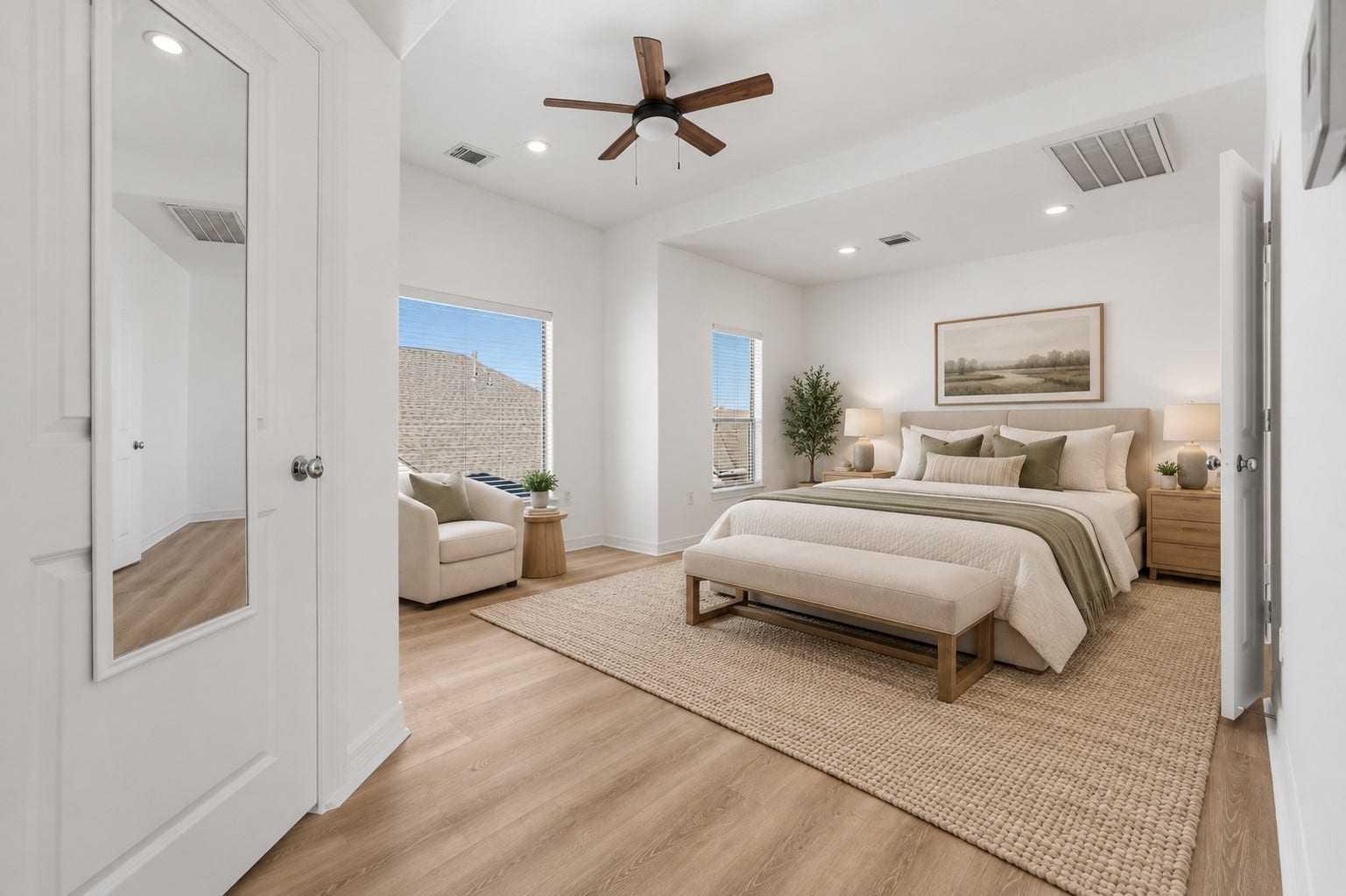 3882 Center Street, Houston, TX 77007 (Virtually staged) The primary bedroom features soft neutral tones, recessed lighting, and warm wood flooring, creating a bright and inviting atmosphere with a timeless appeal.