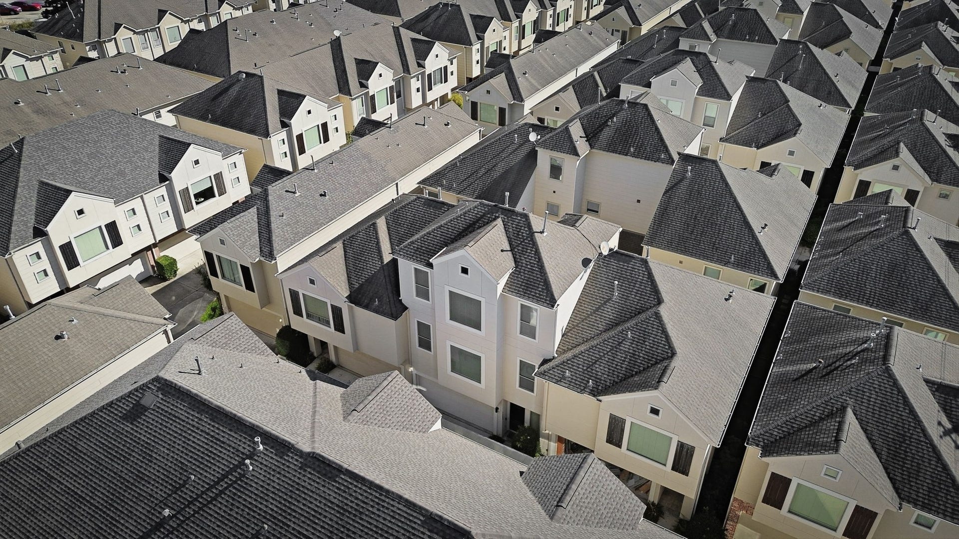 3882 Center Street, Houston, TX 77007 An aerial perspective highlights the communitys uniform architectural style, with multi-story homes, coordinated rooflines, and neatly arranged residences creating a cohesive neighborhood setting.