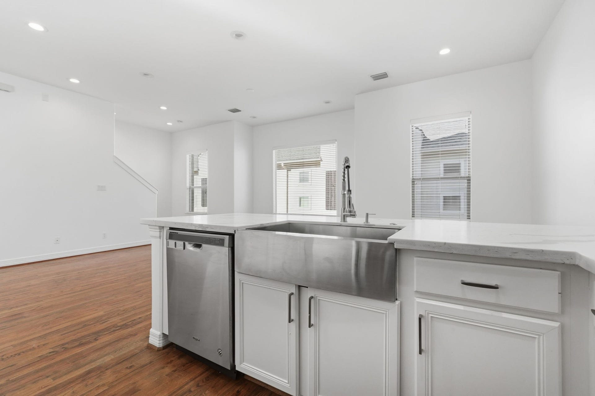 3882 Center Street, Houston, TX 77007 The kitchen features a spacious countertop, a deep stainless steel farmhouse sink, and built-in dishwasher, complemented by crisp white cabinetry for a practical and polished cooking space. (2nd floor)