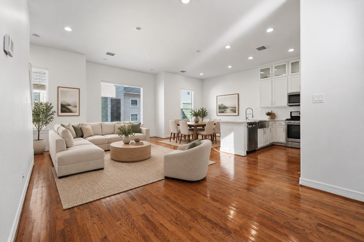 3882 Center Street, Houston, TX 77007 (Virtually staged) Bright, open-concept living and dining areas showcase recessed lighting, clean architectural lines, and a soft neutral palette, creating a seamless flow and a welcoming atmosphere for everyday living.