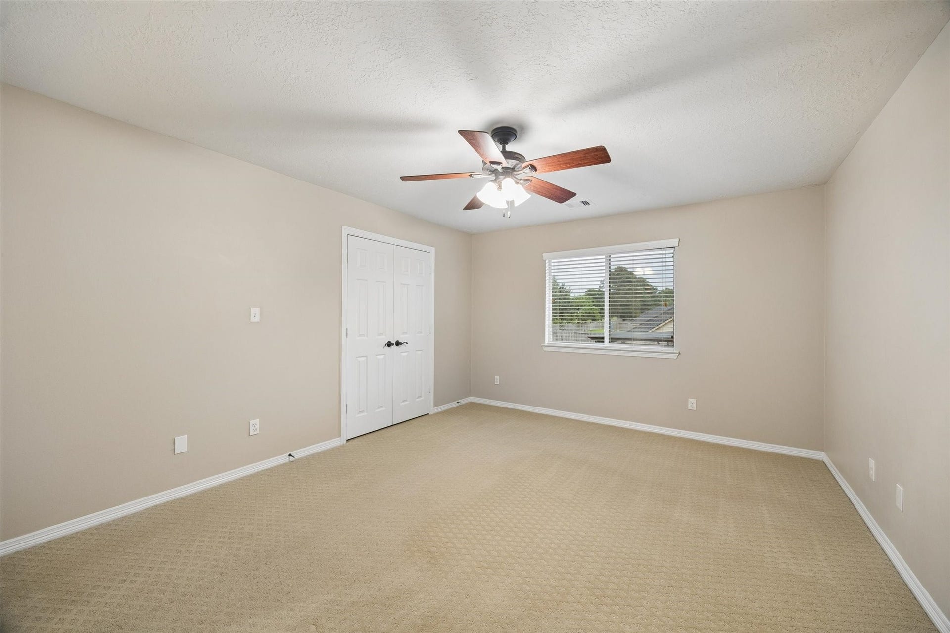 24935 Waterstone Estates Circle W, Tomball, TX 77375 Bathed in natural light, this charming secondary bedroom features ample space and a welcoming atmosphere, ideal for accommodating family or guests in comfort.