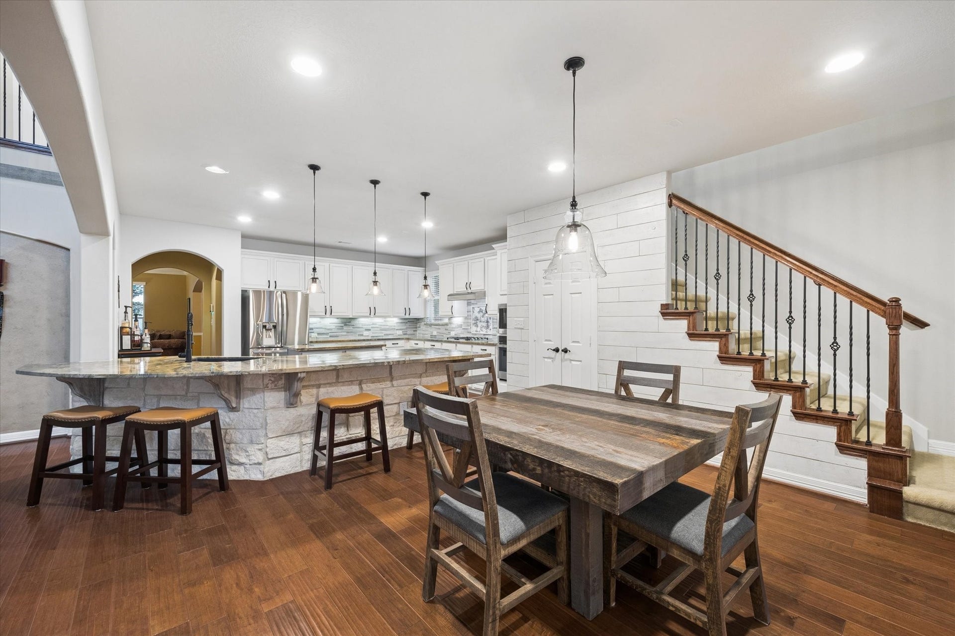 24935 Waterstone Estates Circle W, Tomball, TX 77375 The spacious breakfast area flows seamlessly from the kitchen, offering the perfect setting for casual dining and everyday gatherings. A generous breakfast bar provides additional seating, while recessed LED lighting and the open-concept design create a bright and inviting connection between the kitchen and surrounding living spaces.