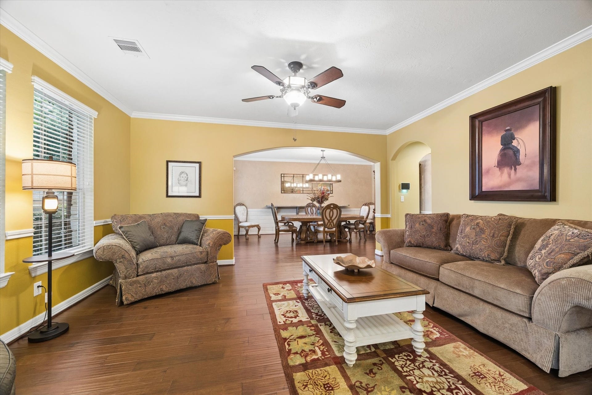 24935 Waterstone Estates Circle W, Tomball, TX 77375 A spacious living area flows seamlessly into the formal dining room, creating an inviting setting for both everyday living and entertaining. Rich hardwood floors, crown molding, and abundant natural light enhance the warmth and character of the space.