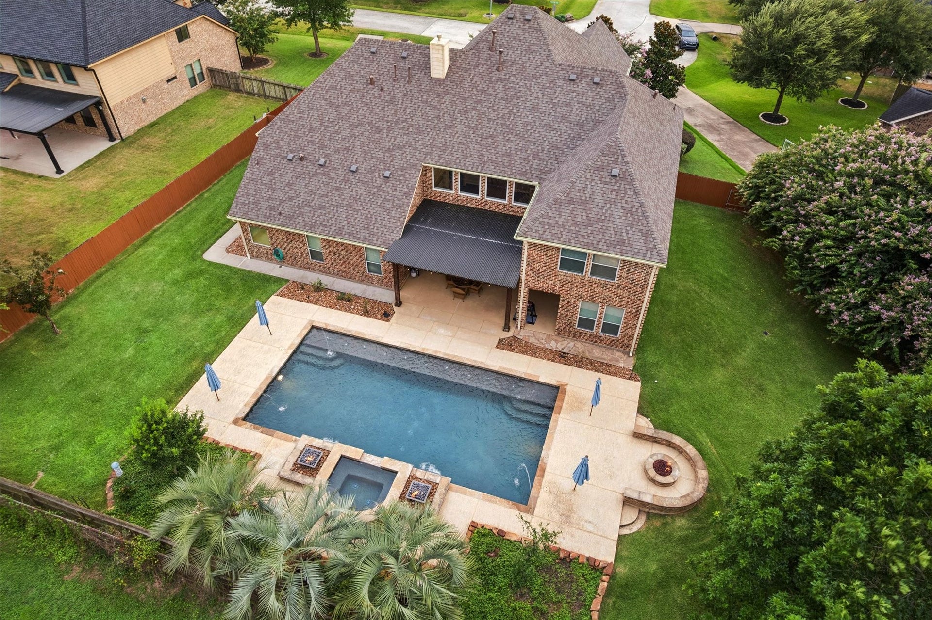 24935 Waterstone Estates Circle W, Tomball, TX 77375 Welcome home to 24935 Waterstone Estates Circle, an exceptional property located in the acclaimed Waterstone Estates community in Tomball. This stunning aerial view showcases the homes expansive backyard, resort-style pool, and inviting outdoor living spaces.