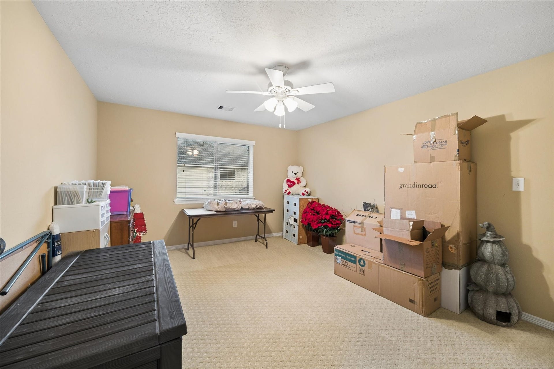 24935 Waterstone Estates Circle W, Tomball, TX 77375 Filled with natural light, this generously sized secondary bedroom currently used as storage offers a comfortable and inviting retreat.
