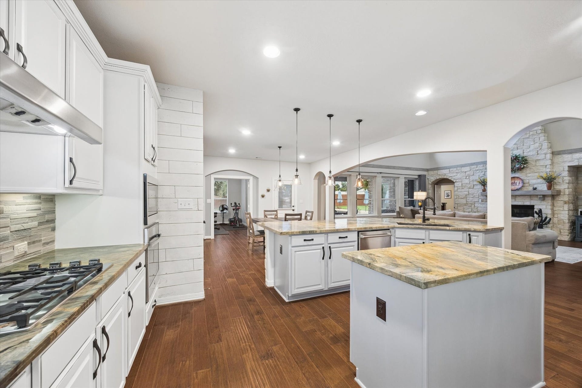 24935 Waterstone Estates Circle W, Tomball, TX 77375 The spacious kitchen offers an abundance of cabinetry and generous counter space, thoughtfully designed for both everyday living and entertaining. Its open layout creates a seamless connection to the breakfast area and family room, allowing the homes impressive spaces to flow together beautifully.