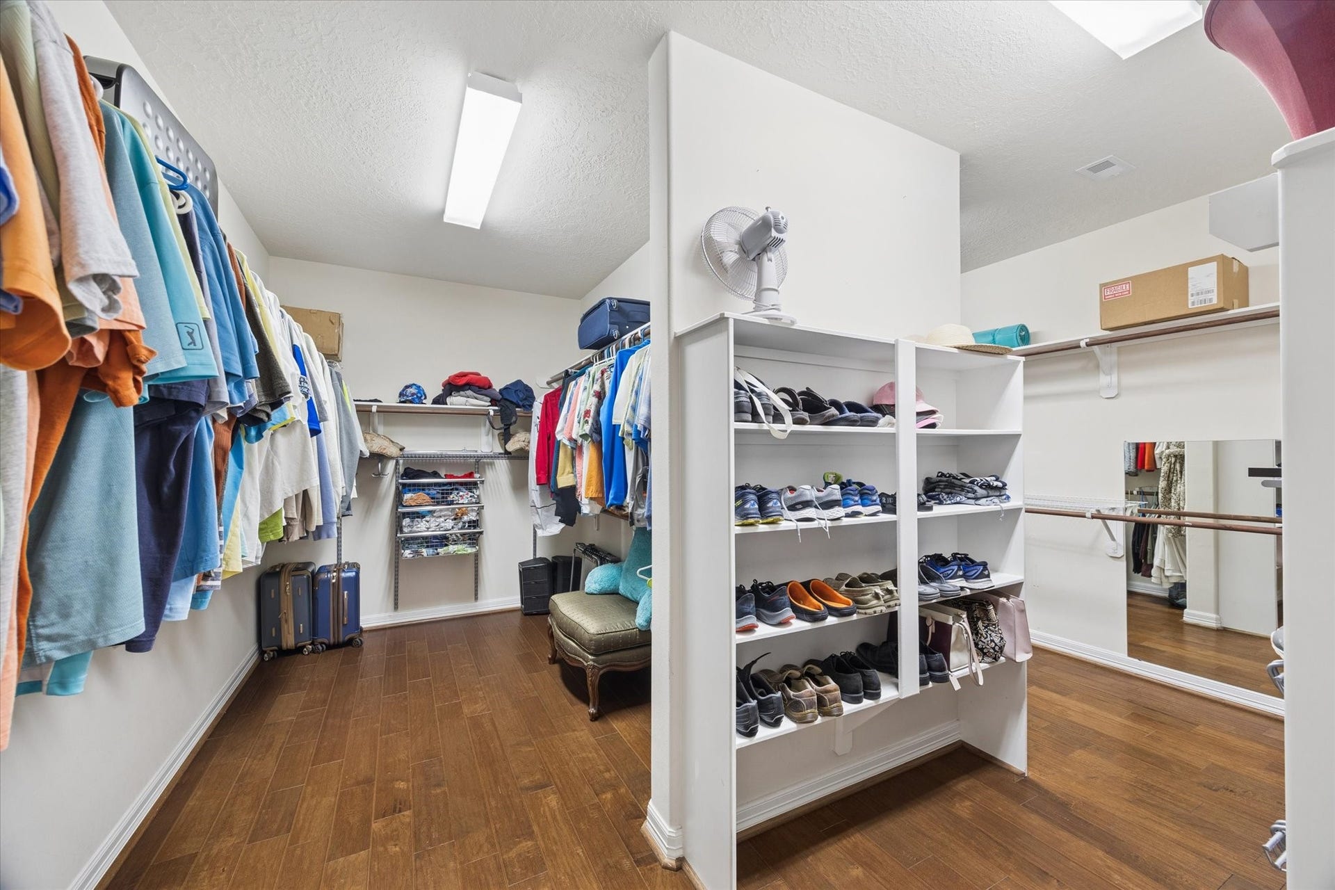 24935 Waterstone Estates Circle W, Tomball, TX 77375 The generously sized primary walk-in closet offers exceptional storage with extensive hanging space, built-in shelving, and dedicated areas for shoes and accessories. The well-designed layout provides ample room to keep everything organized while maintaining an open and functional feel.