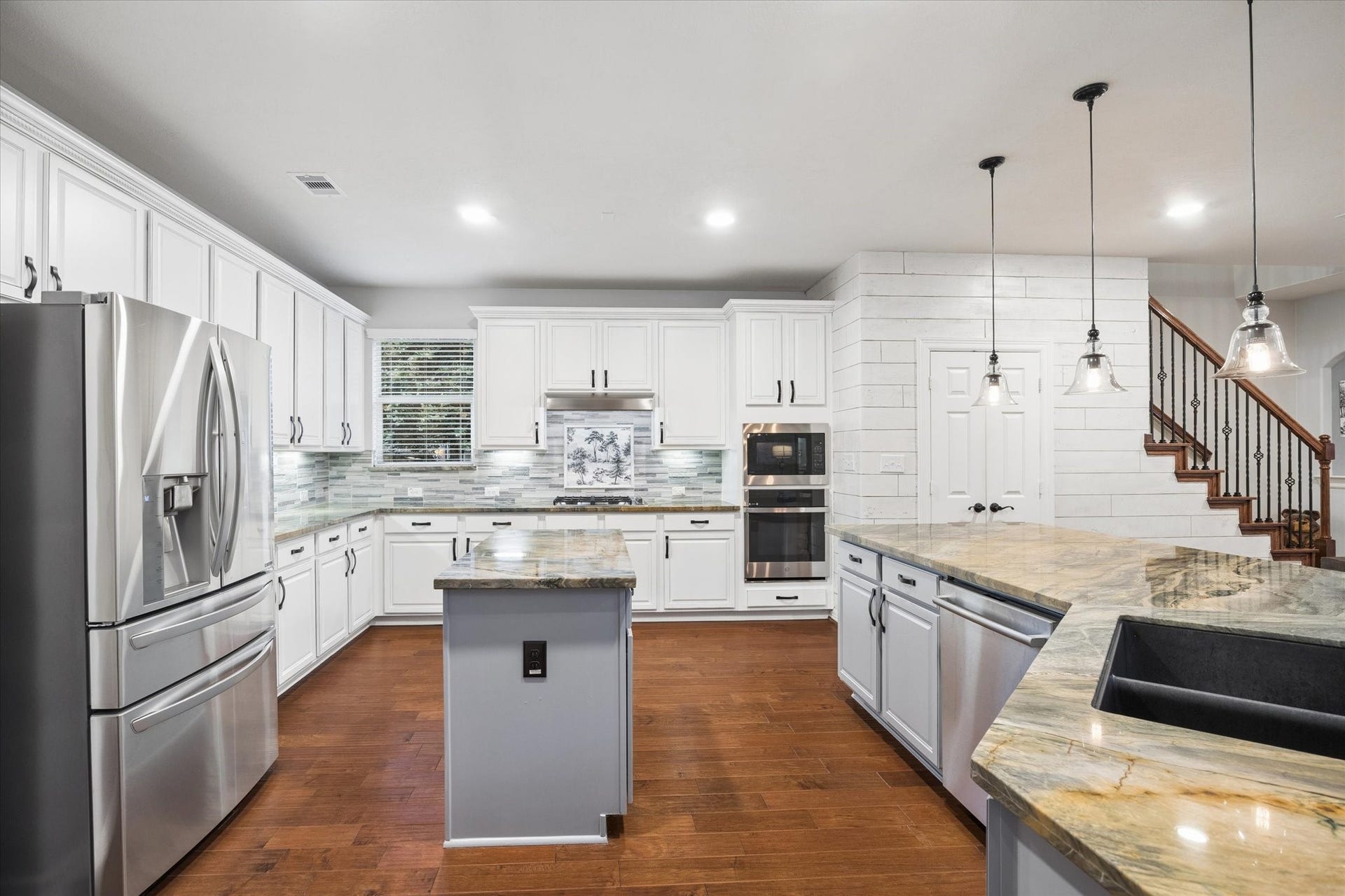24935 Waterstone Estates Circle W, Tomball, TX 77375 At the heart of the home, this spacious kitchen blends style and functionality with abundant cabinetry, expansive countertops, stainless steel appliances, and generous prep space. Its open design flows seamlessly into the family and breakfast areas, creating an inviting setting for everyday living and entertaining.