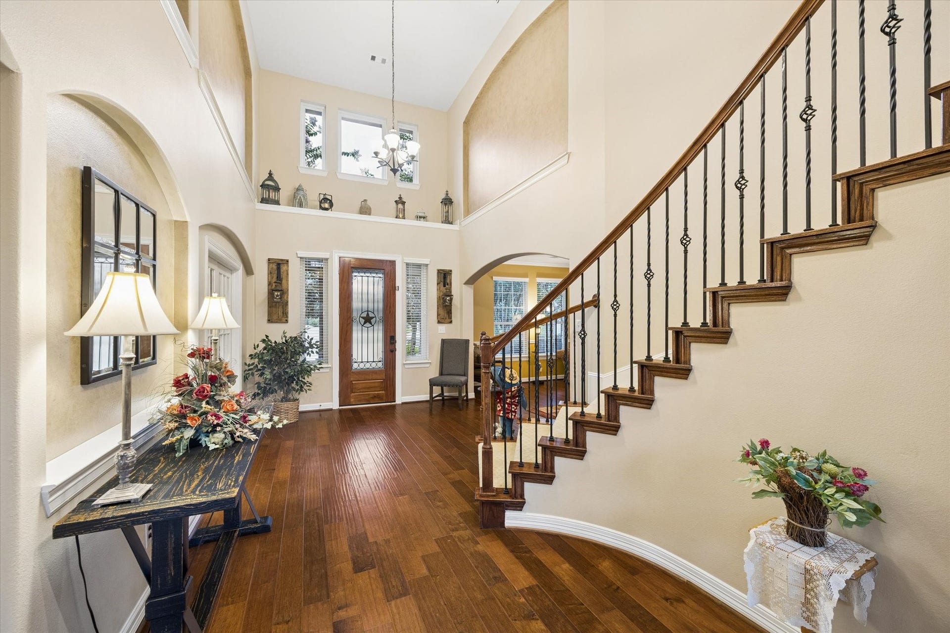 24935 Waterstone Estates Circle W, Tomball, TX 77375 A different perspective of the grand entry highlights the soaring ceilings, rich hardwood floors, and elegant staircase with wrought-iron details. Abundant natural light enhances the open and welcoming design, setting the tone for the impressive spaces throughout the home.