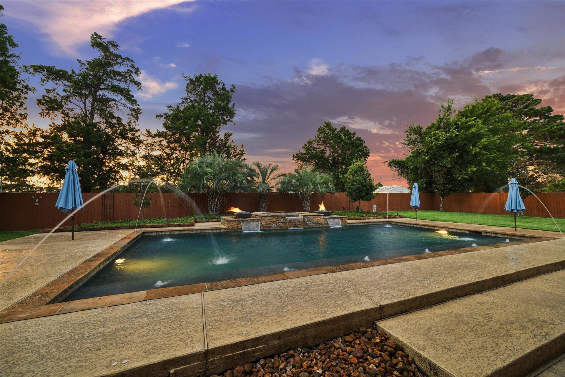 24935 Waterstone Estates Circle W, Tomball, TX 77375 A spectacular backyard retreat featuring a resort-style pool with cascading water features, fire accents, and lush landscapingan exceptional setting for relaxing, entertaining, and enjoying beautiful Texas evenings.