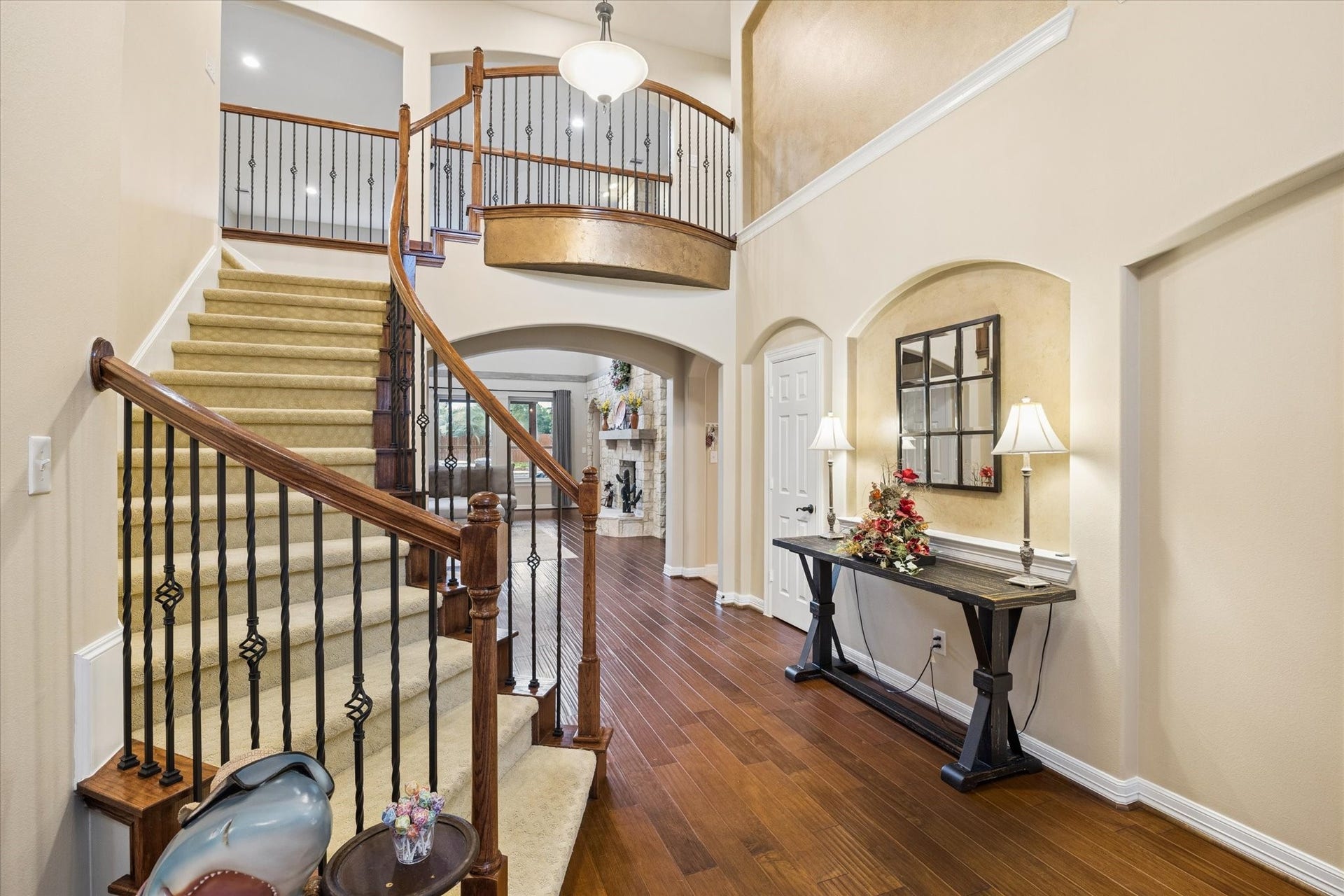 24935 Waterstone Estates Circle W, Tomball, TX 77375 grand entry welcomes you inside, where soaring ceilings, rich hardwood floors, and an elegant staircase create an impressive introduction to the home. Thoughtful architectural details and an open design offer a glimpse of the beautiful spaces beyond.