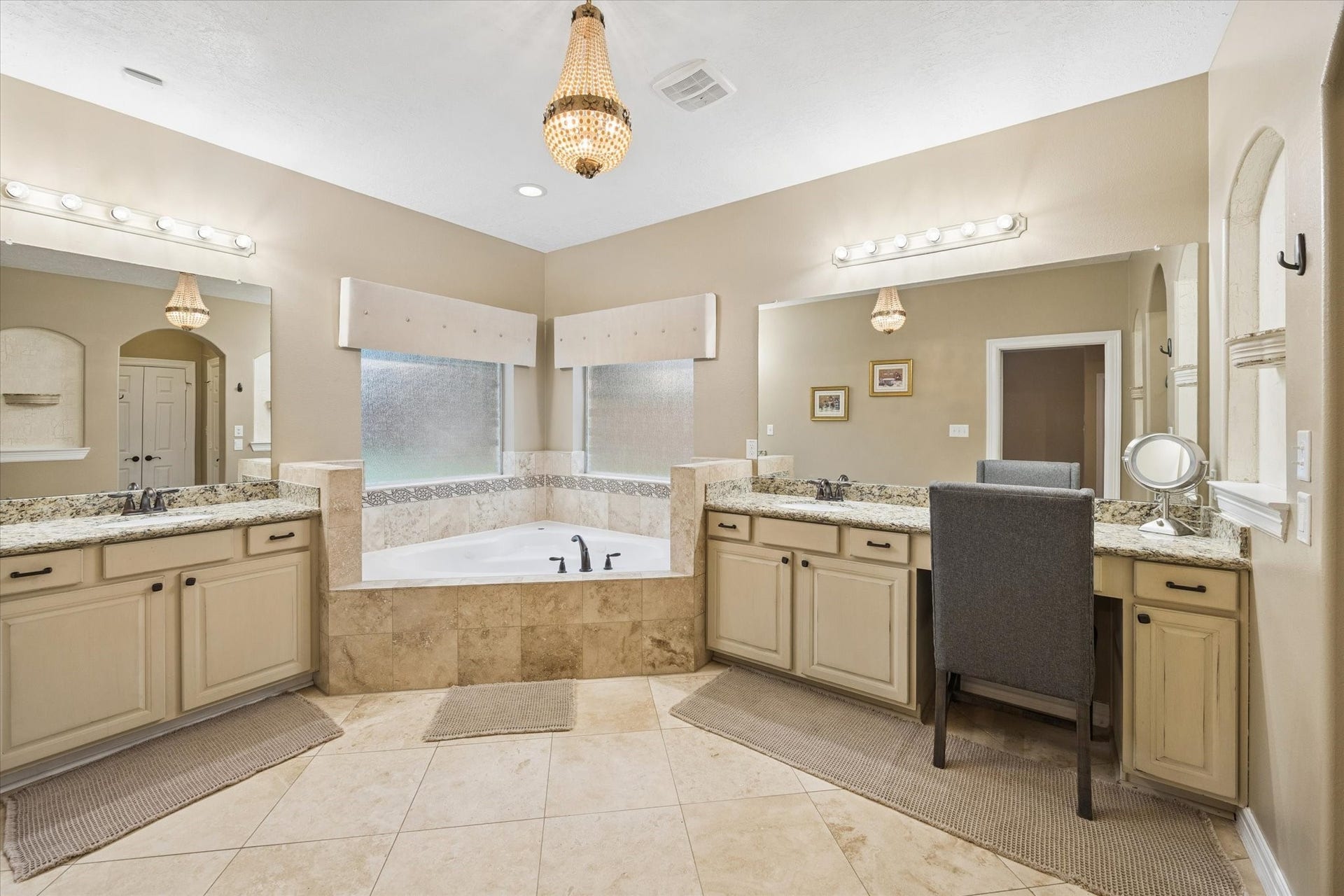24935 Waterstone Estates Circle W, Tomball, TX 77375 The primary en-suite bath offers a relaxing retreat with dual vanities, granite countertops, abundant cabinetry, and a large jetted soaking tub surrounded by tile. Generous proportions and thoughtful design create a comfortable and functional space for everyday living.