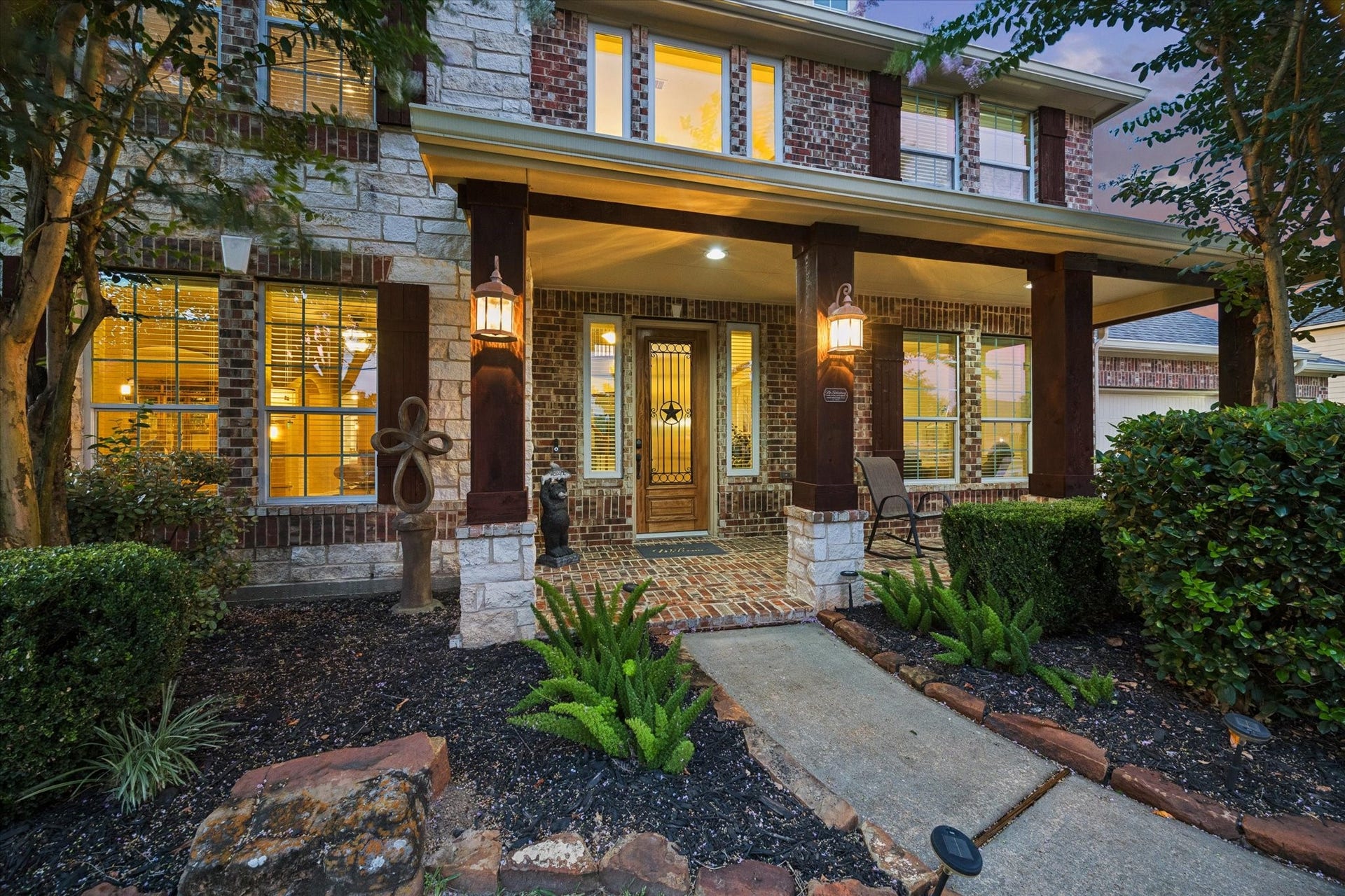 24935 Waterstone Estates Circle W, Tomball, TX 77375 A closer look at the homes beautiful exterior, where classic brick and stone accents create timeless appeal. The inviting covered front porch offers a warm welcome and sets the tone for the exceptional spaces that await inside.