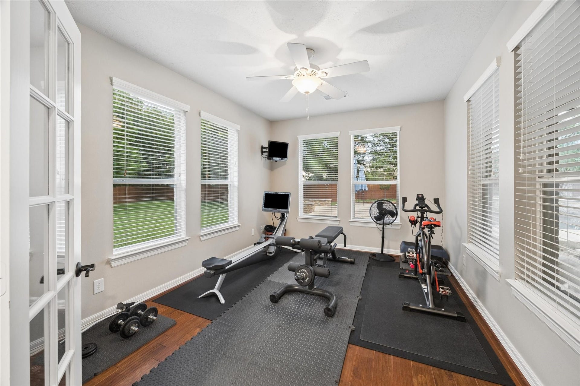 24935 Waterstone Estates Circle W, Tomball, TX 77375 A versatile flex room conveniently located near the main living area offers abundant natural light and views of the backyard. Currently used as a home gym, this flexible space can easily adapt to a private sitting room, home office, fitness studio, or personal retreat.
