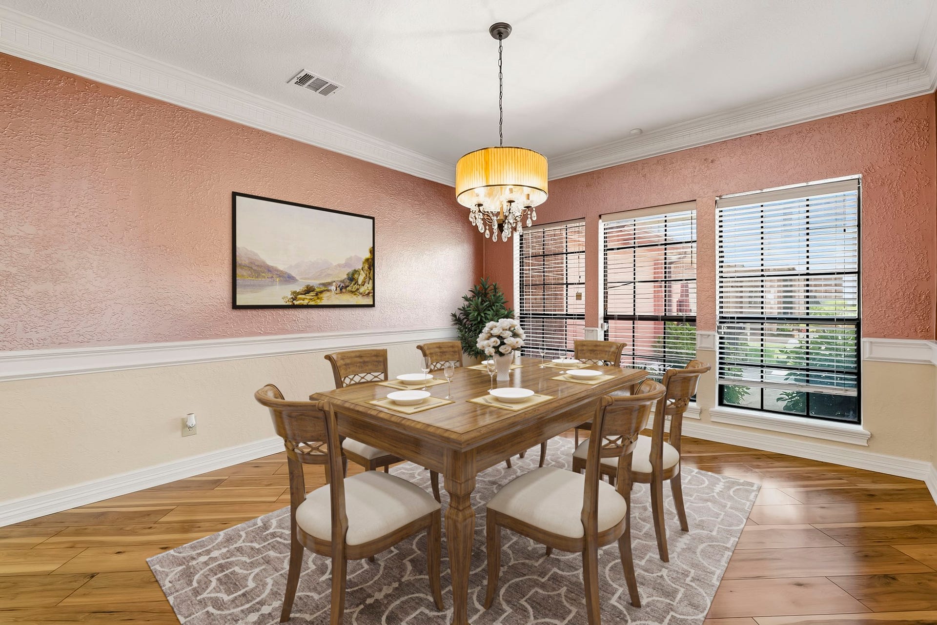 Virtually Staged: Sophisticated formal dining area highlighting hardwood floors, a drum chandelier with crystal accents, crown molding, and expansive windows filling the room with natural light.