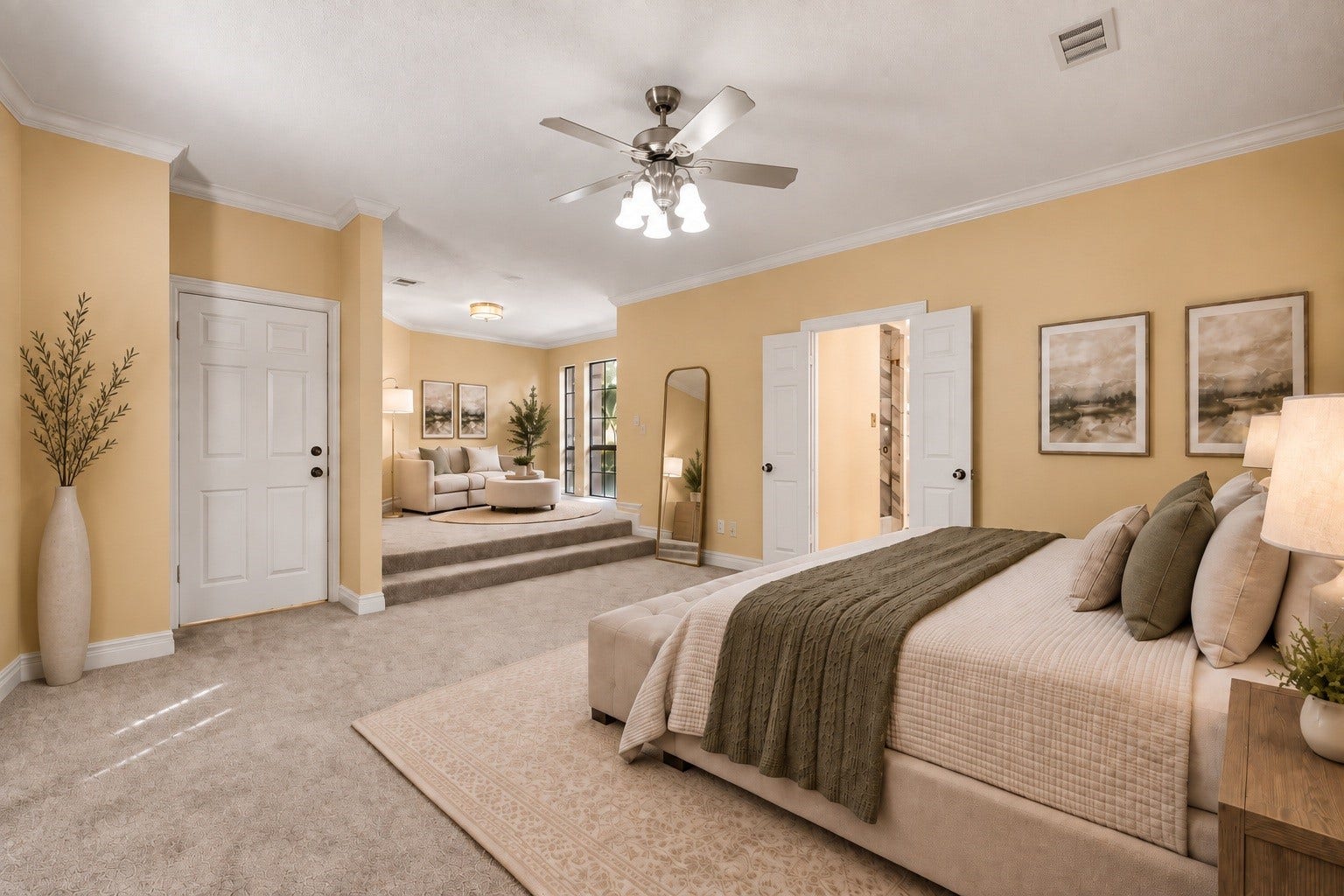 Virtually Staged: Generous primary bedroom suite featuring a unique step-up sitting room, plush carpeting, ceiling fan, and double doors opening into a private en-suite bathroom.