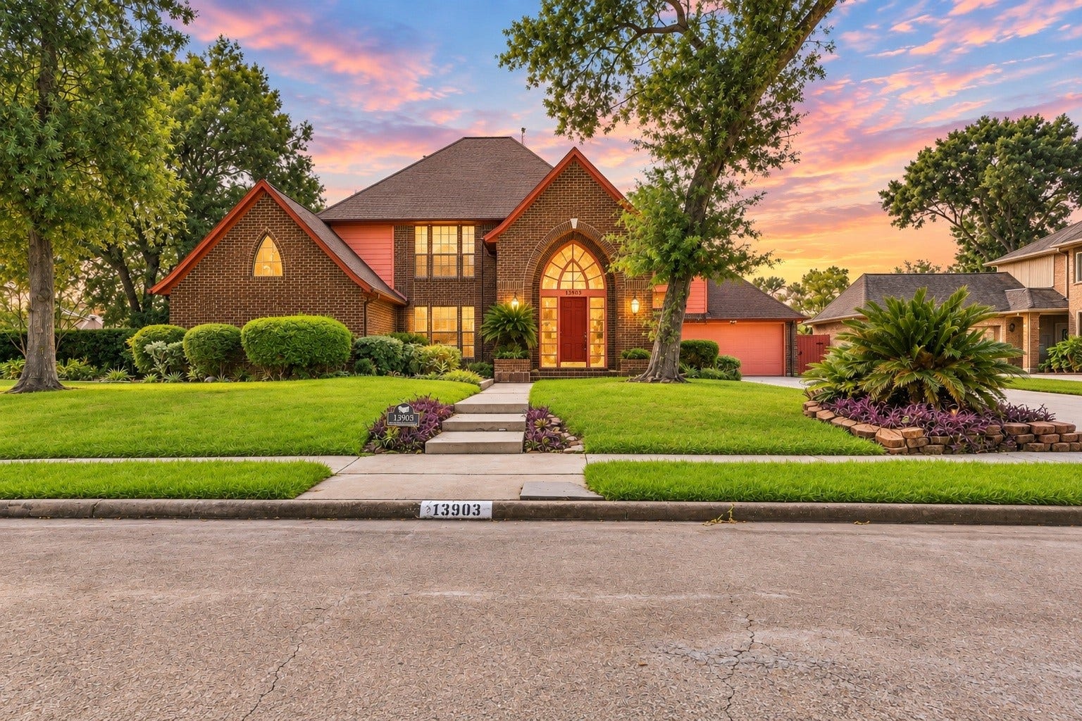 Welcome to paradise at sunset! Glowing with warmth from every window, this inviting home offers incredible curb appeal, a grand arched entrance, elegant walkway steps, and beautifully maintained grounds.