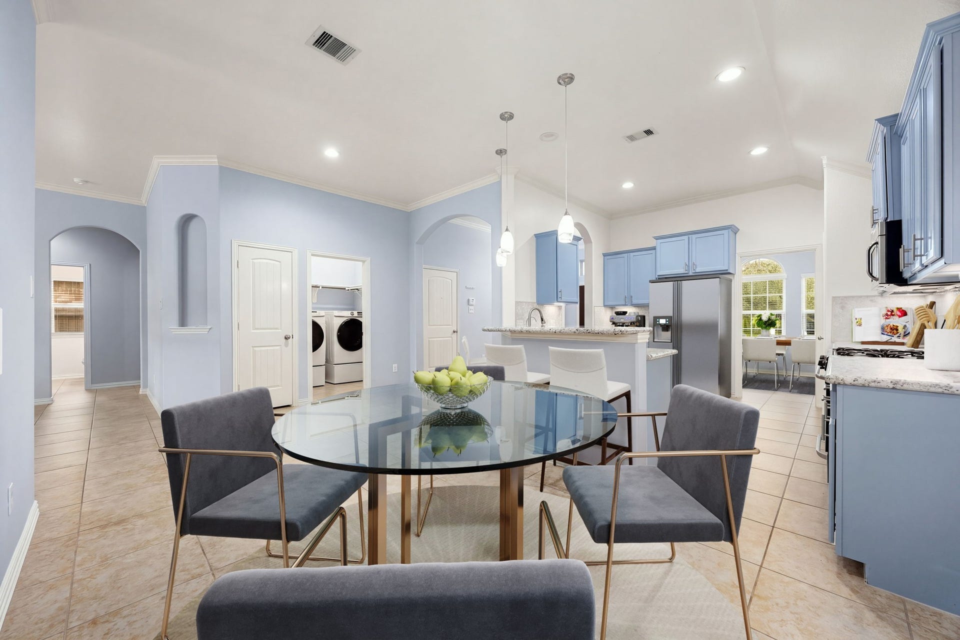 The bright, sunlit breakfast nook sits perfectly off the kitchen, offering a cozy spot for morning coffee with convenient proximity to the adjacent laundry room. *Virtually Staged