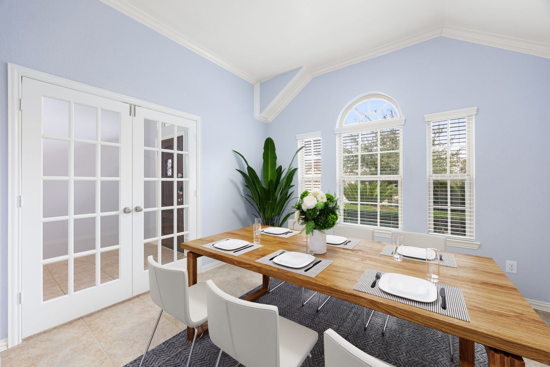 Elegant formal dining space featuring high ceilings, ample natural light, and French doors that provide excellent flexibility for a quiet work-from-home setup. *Virtually Staged