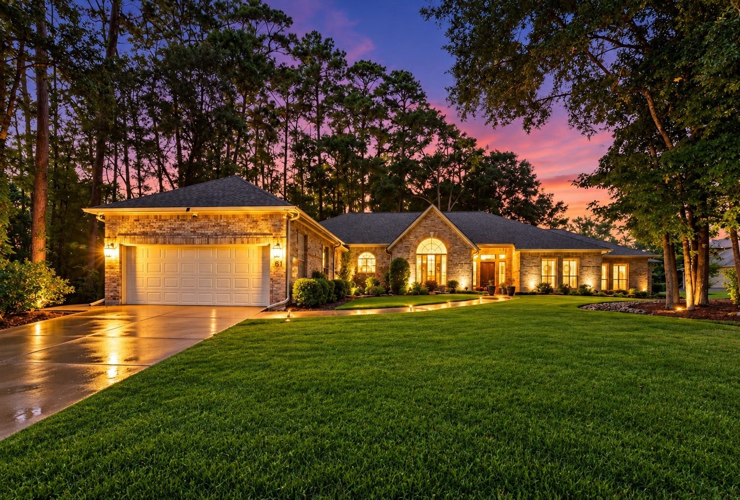 901 Longmire Road, #51, Conroe, TX 77304 Breathtaking twilight views showcase this elegant single-story residence, beautifully framed by majestic trees, lush landscaping & warm architectural lighting.