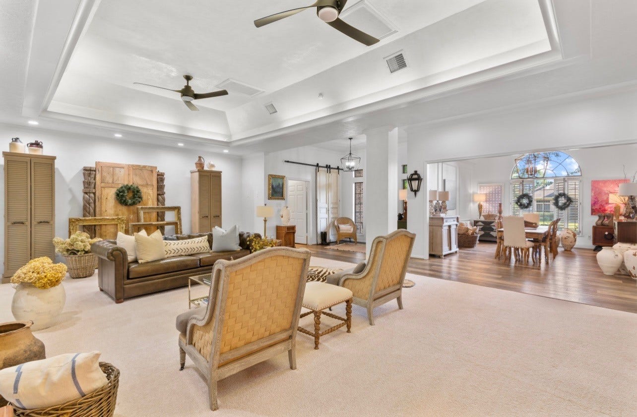 901 Longmire Road, #51, Conroe, TX 77304 Impressive grand living room featuring soaring tray ceilings, elegant architectural details, recessed lighting & an expansive open layout that flows beautifully into the formal dining areaperfect for sophisticated entertaining.