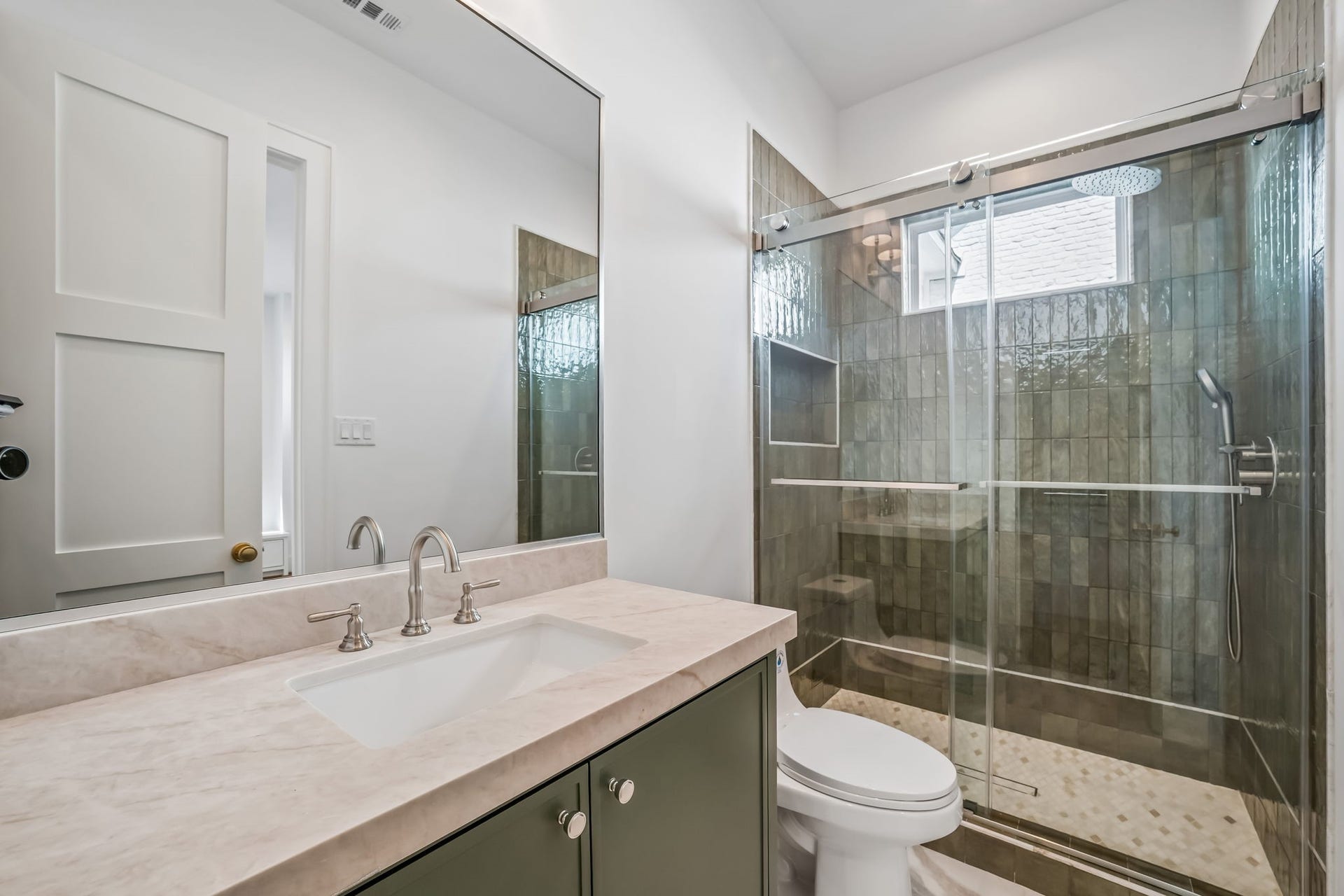 Private en-suite bath complete with a spacious walk-in shower.