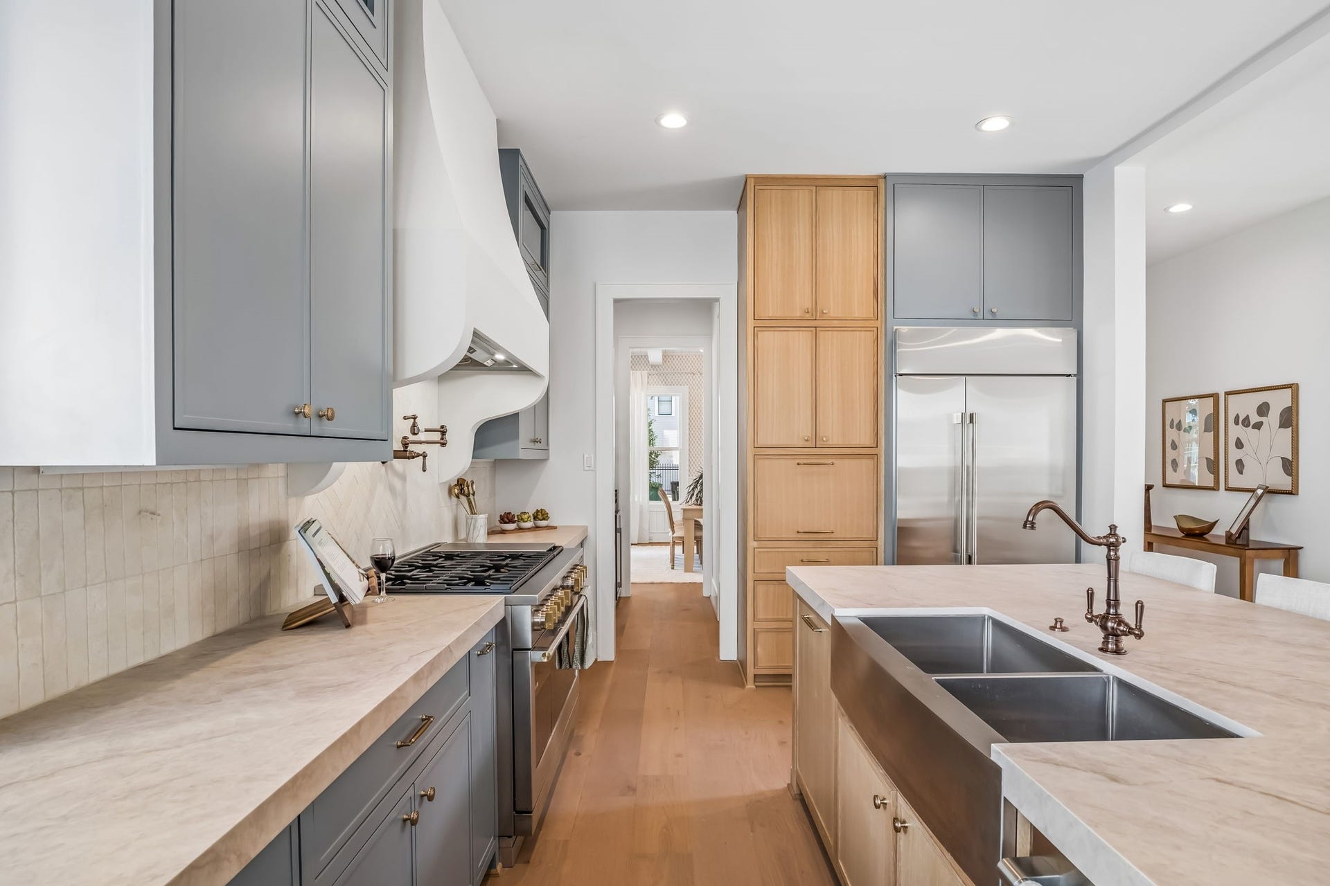 The 42-inch refrigerator conveys with the sale of the home, while a dedicated appliance garage provides additional storage for small appliances and everyday devices, keeping countertops clean and clutter-free.