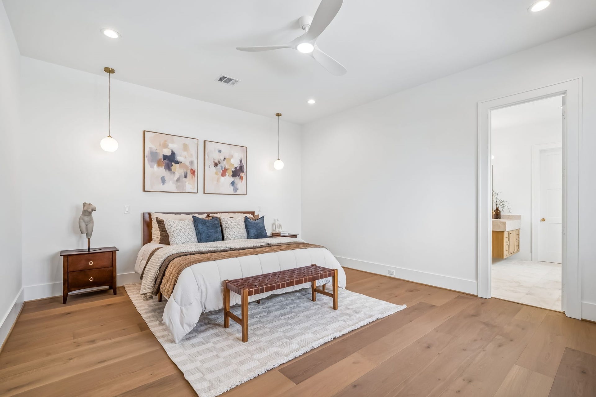 One of two luxurious primary suites, thoughtfully positioned on separate levels, with one on the first floor and the second upstairs.