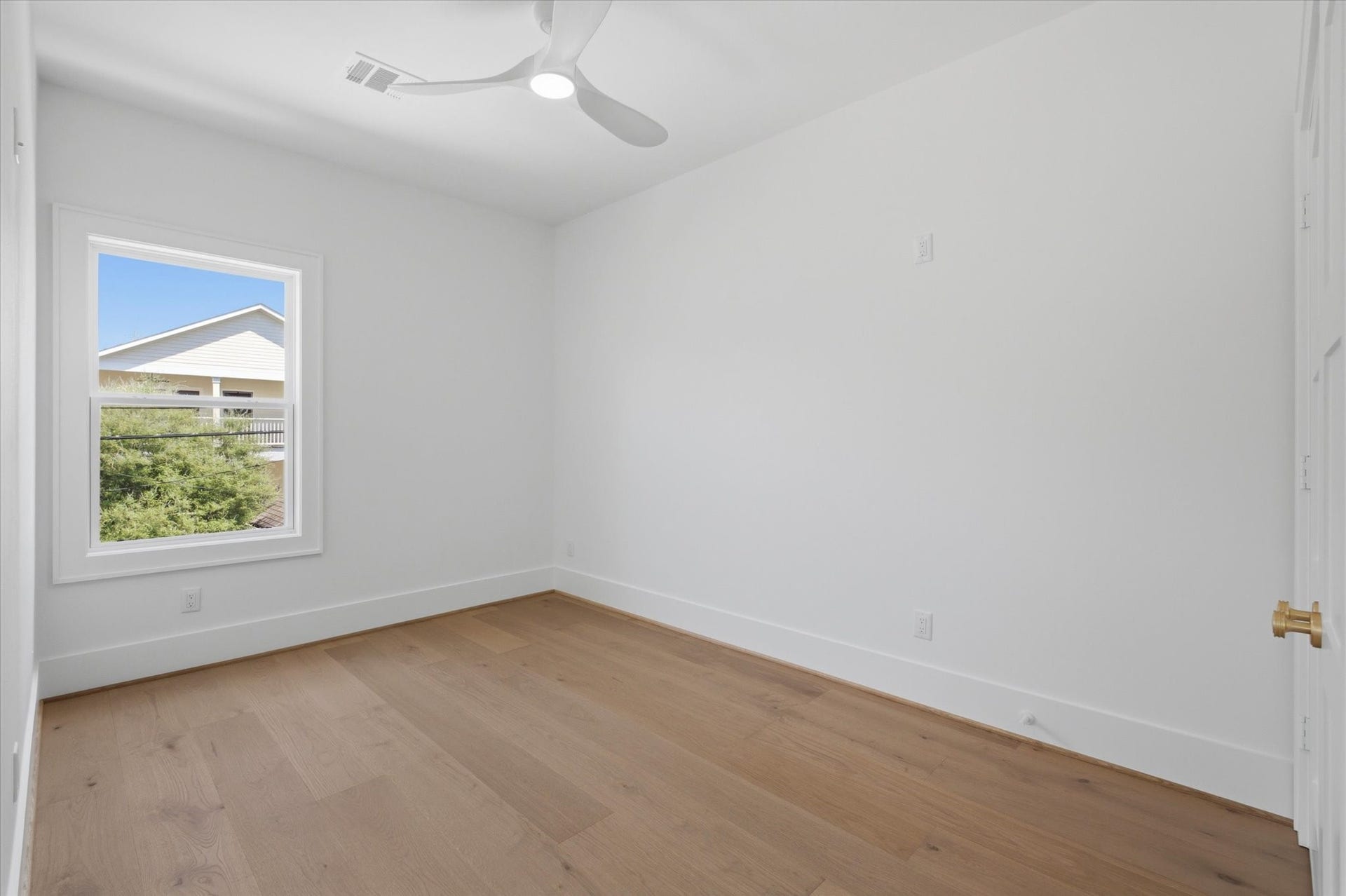 A full-size bedroom completes the garage apartment, featuring a spacious closet and Cat5e wiring for seamless connectivity.