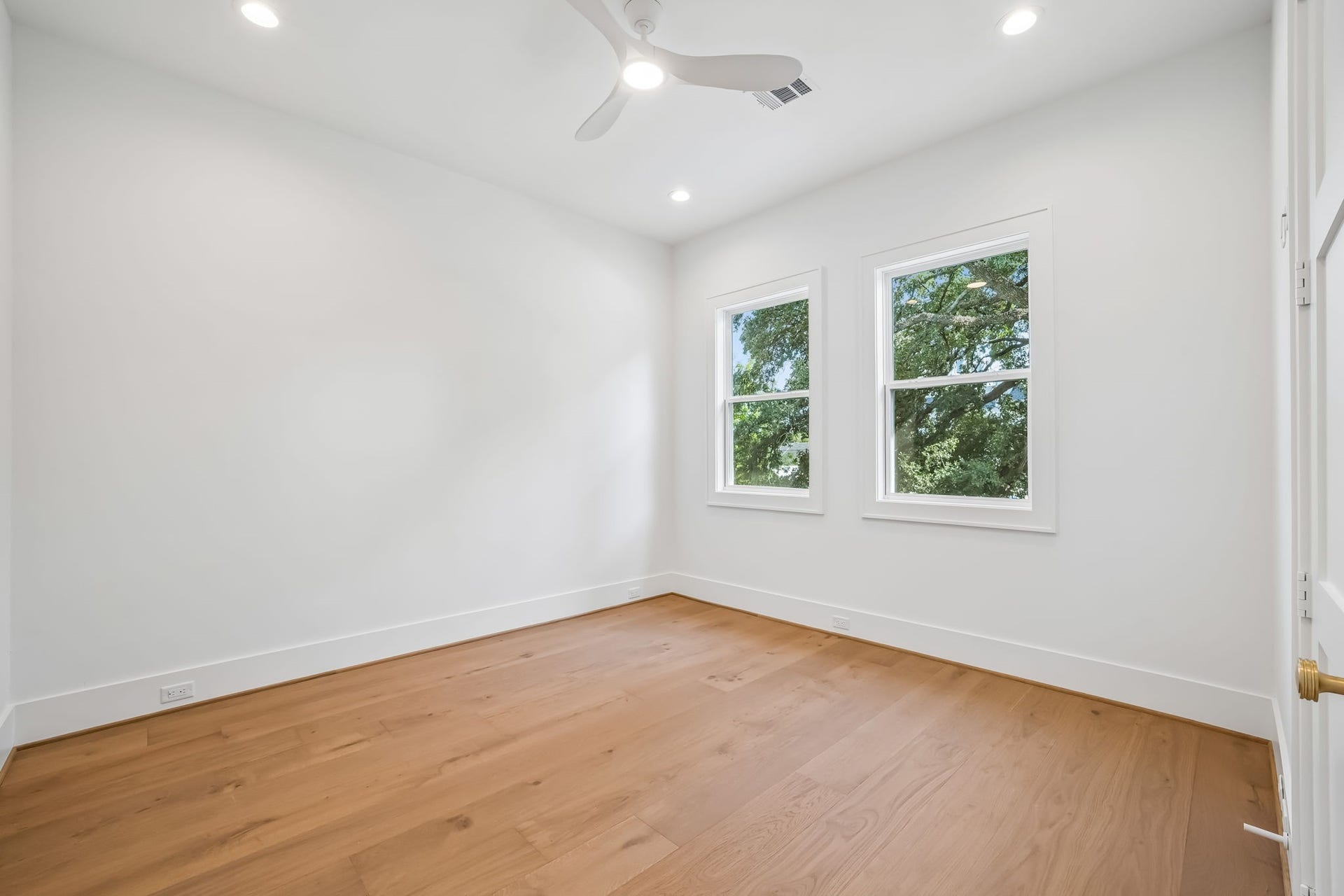 Another view of one of the three secondary bedrooms, showcasing beautiful windows that fill the space with natural light.