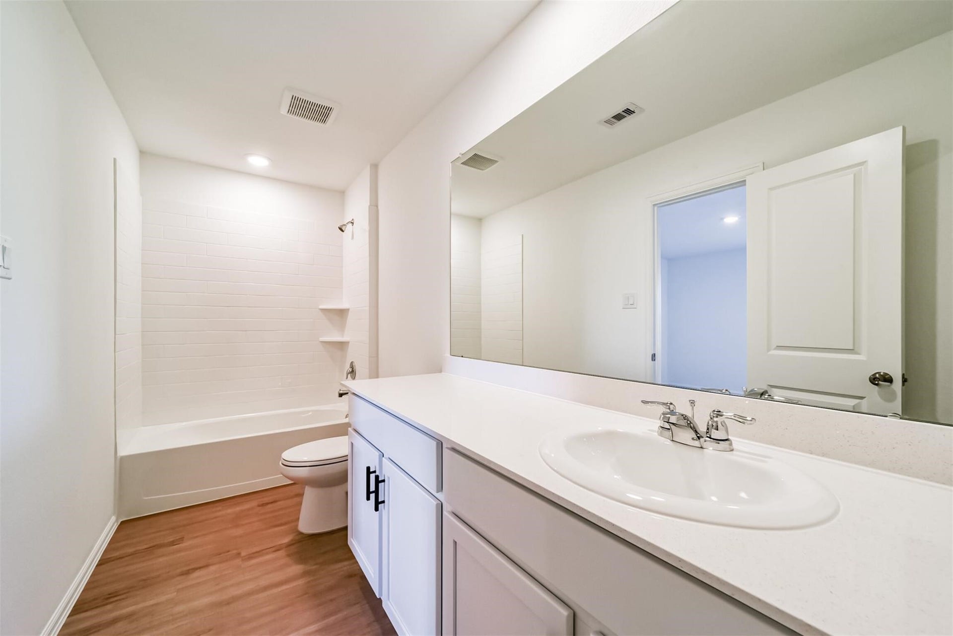 primary bathroom featuring a relaxing soaking tub, separate shower, and a large vanity
