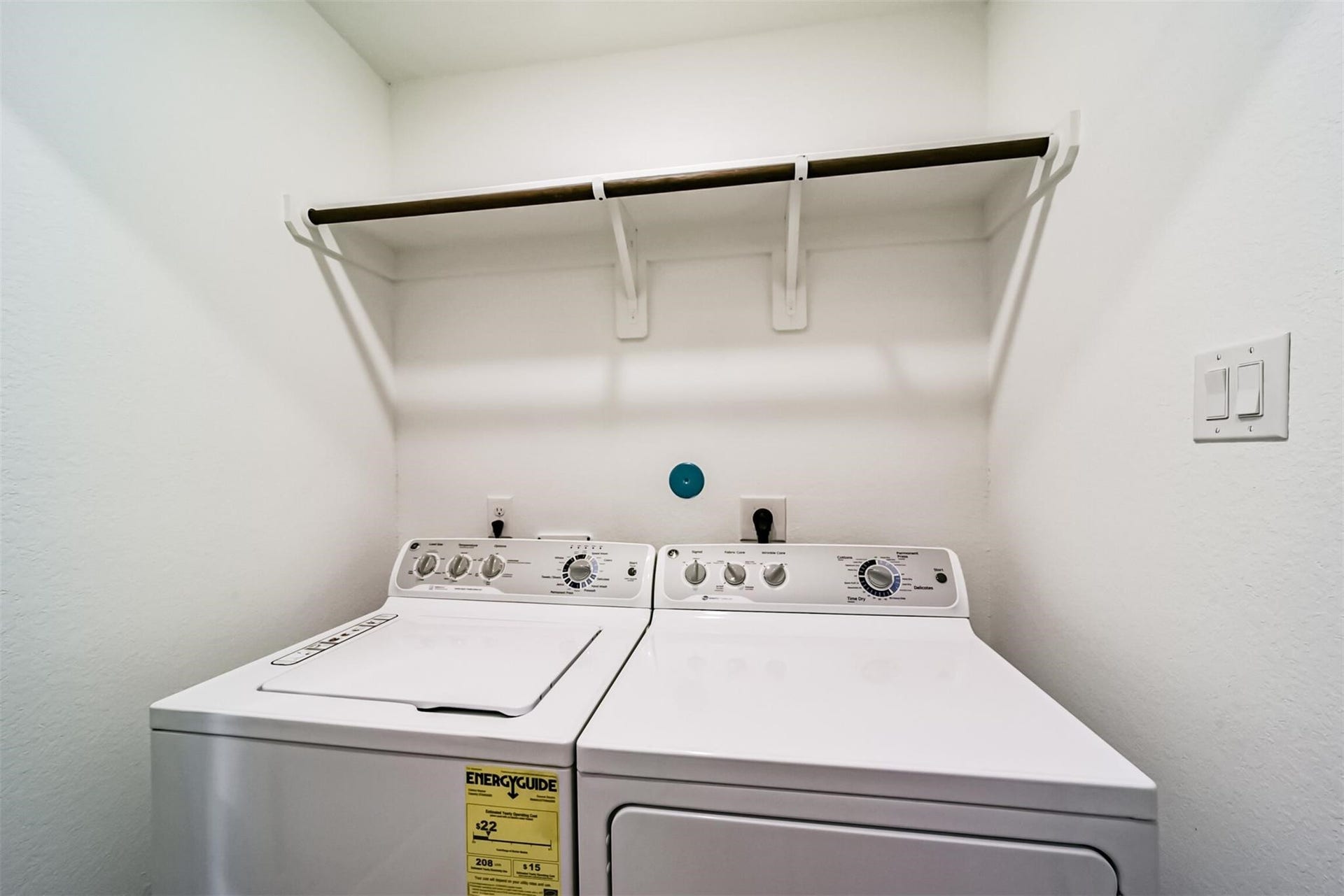 Convenient laundry room equipped with a washer and dryer, ready for you inside the house!